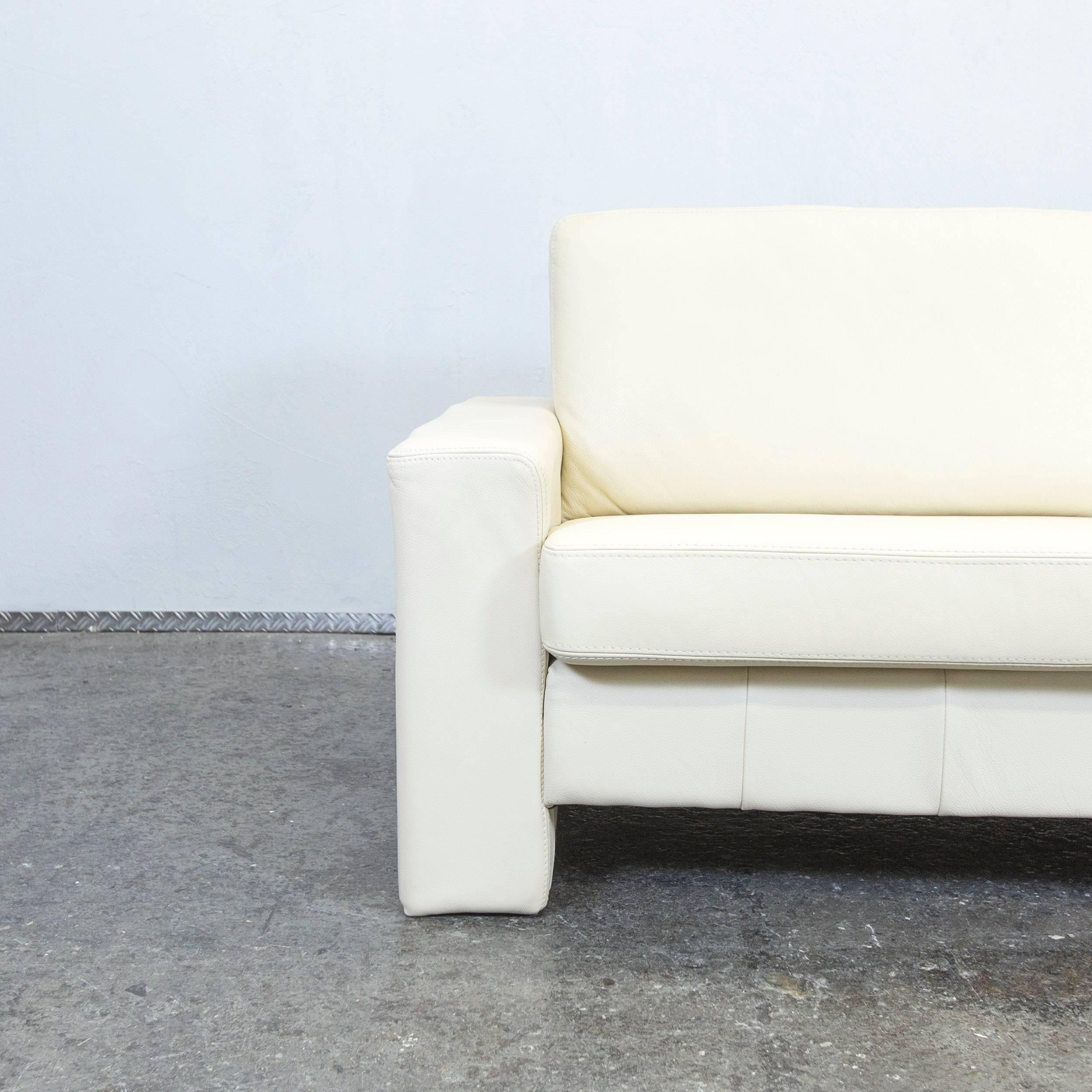 Crème white colored designer leather sofa in a minimalistic and modern style, designed for pure comfort.