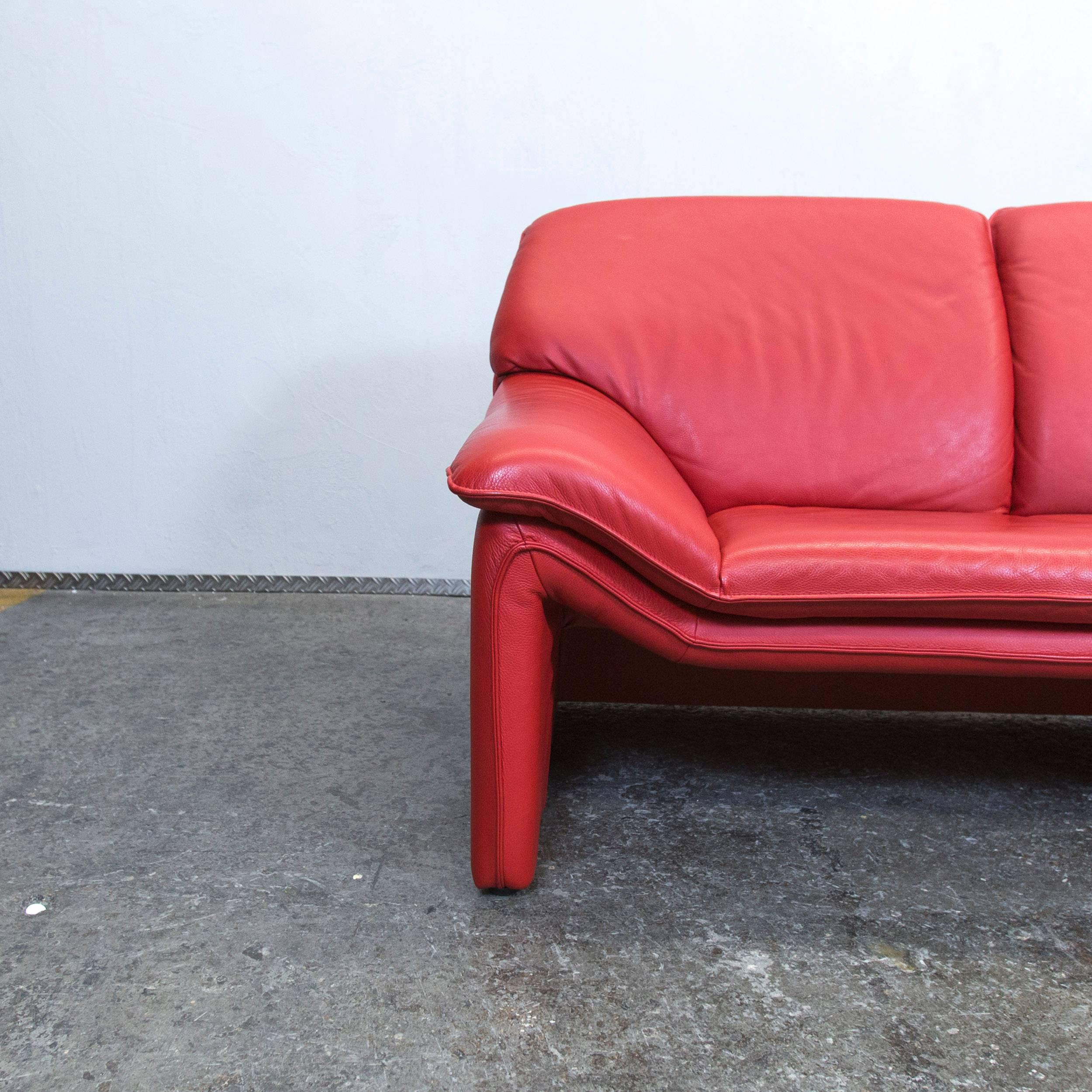 Red colored original Laauser designer leather sofa in a minimalistic and modern design.