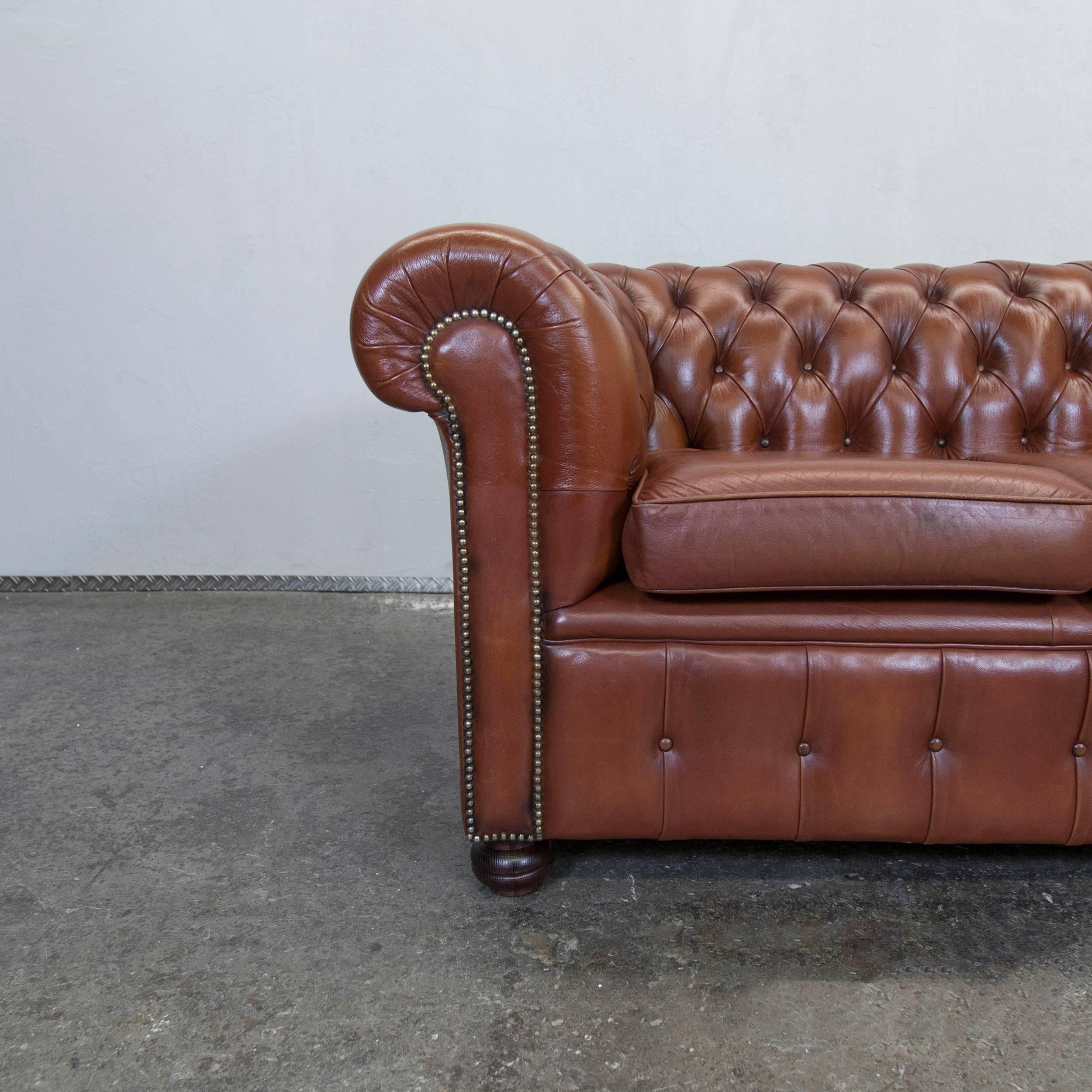 Brown colored Chesterfield leather sofa in a vintage style, designed for pure comfort and elegance.