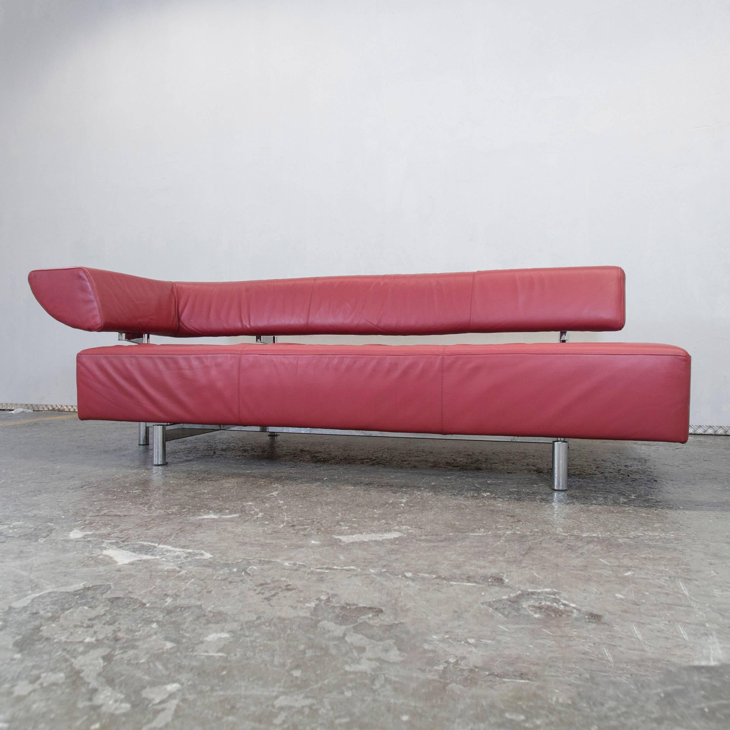Red colored original COR Arthe designer leather sofa in a minimalistic and modern design, with a convenient function.