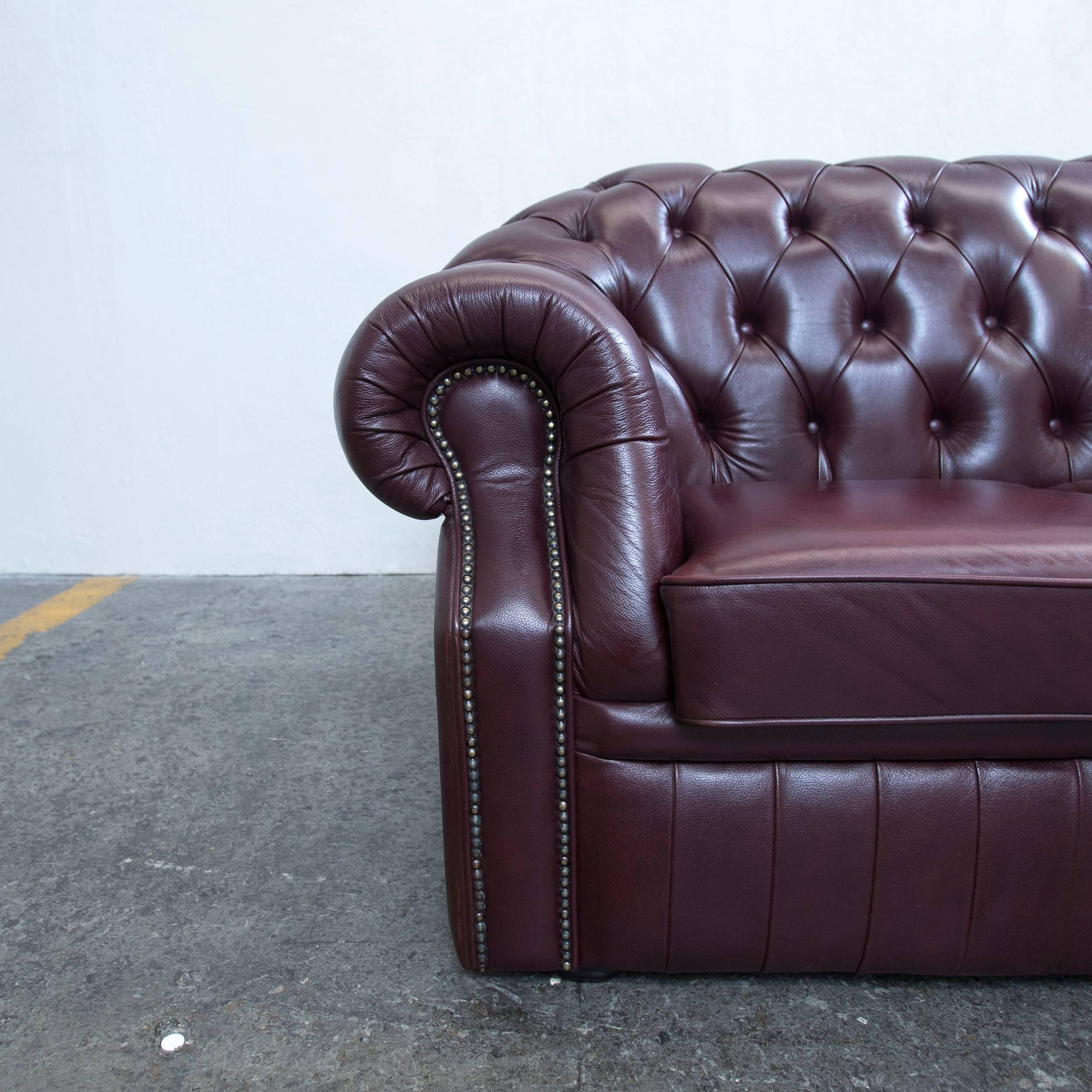 Brown red colored Chesterfield leather sofa in a vintage style, made for pure comfort and elegance.