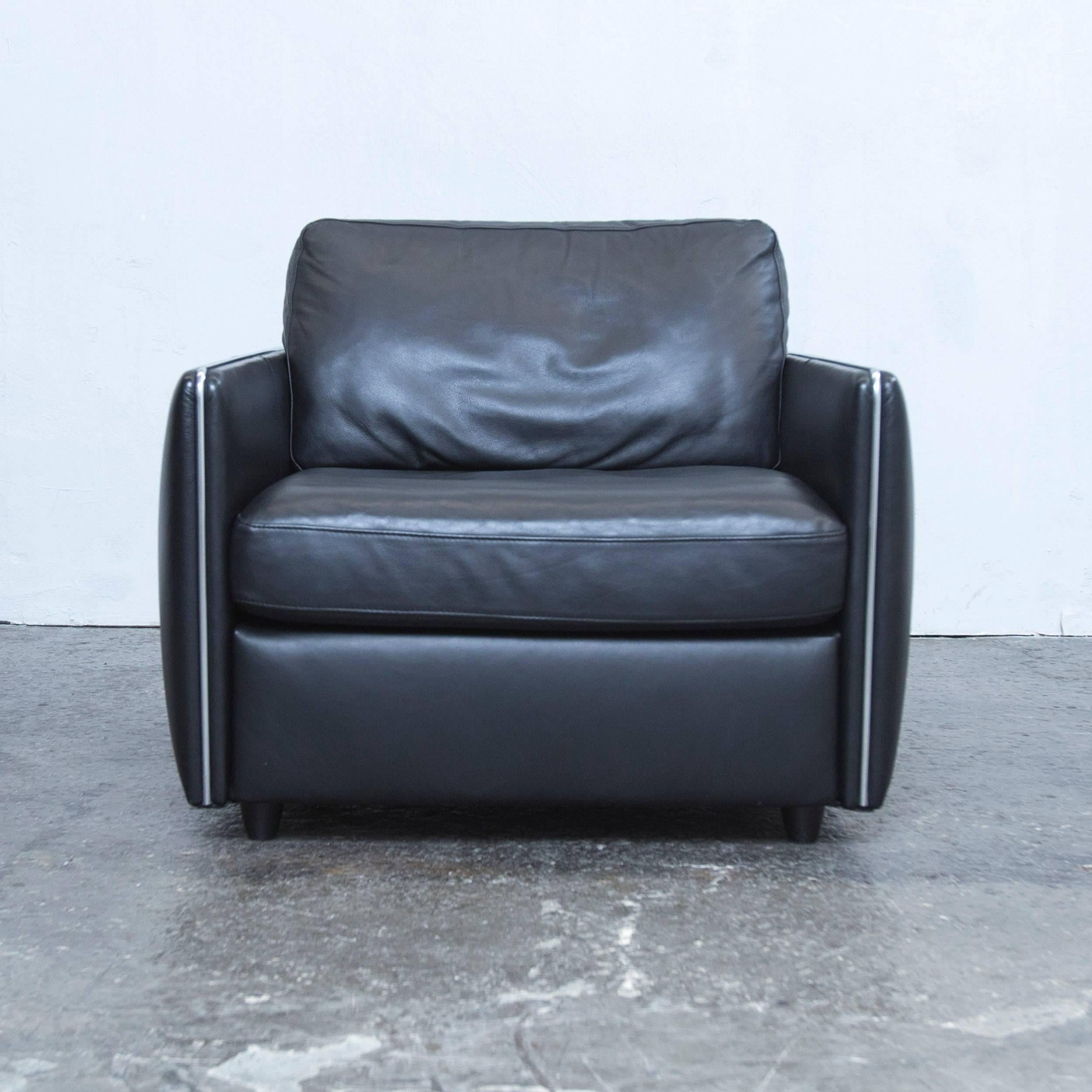 Black colored original Musterring leather armchair in a modern and minimalistic style, made for pure comfort.