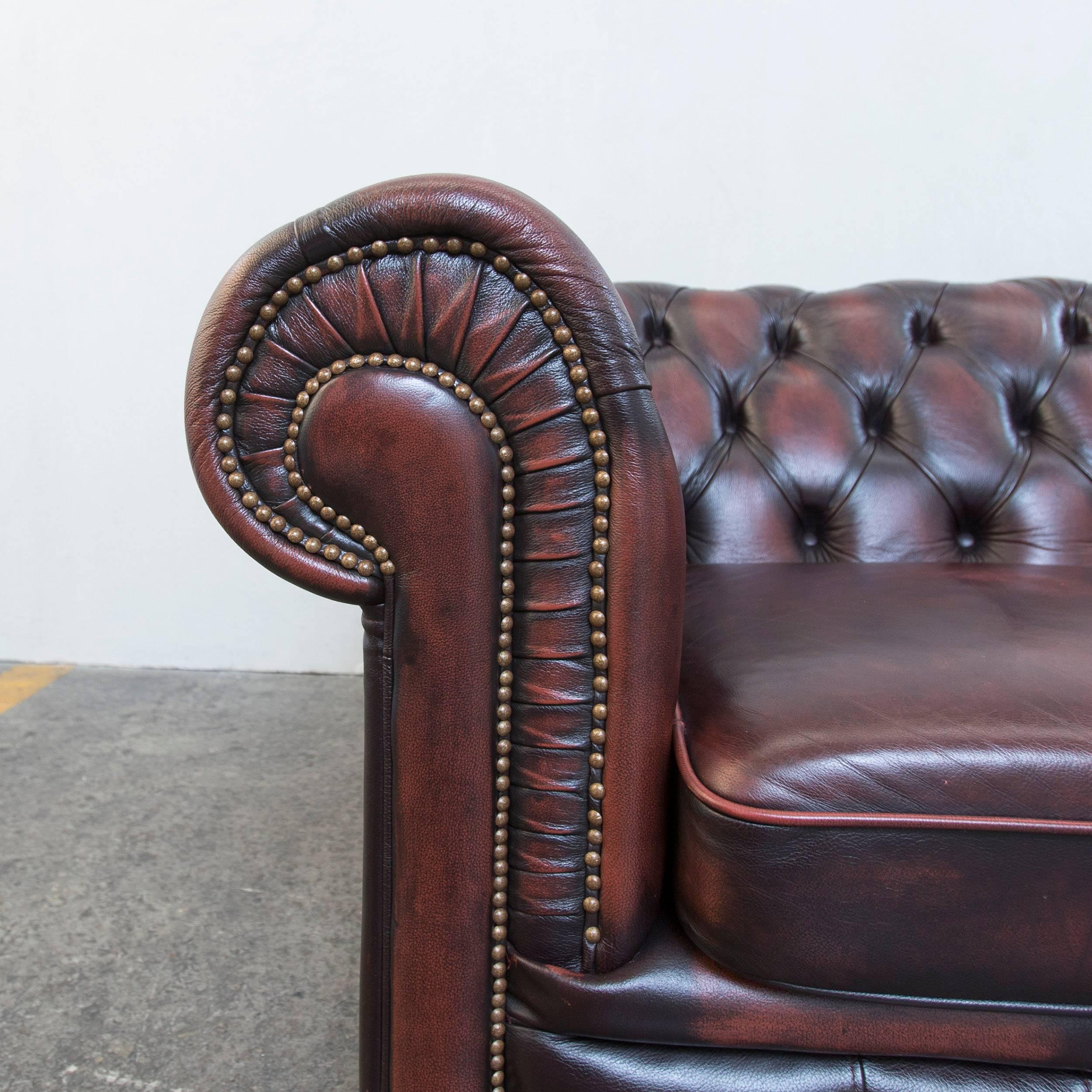 Brown colored original Chesterfield leather sofa in a vintage style made for pure comfort and elegance.