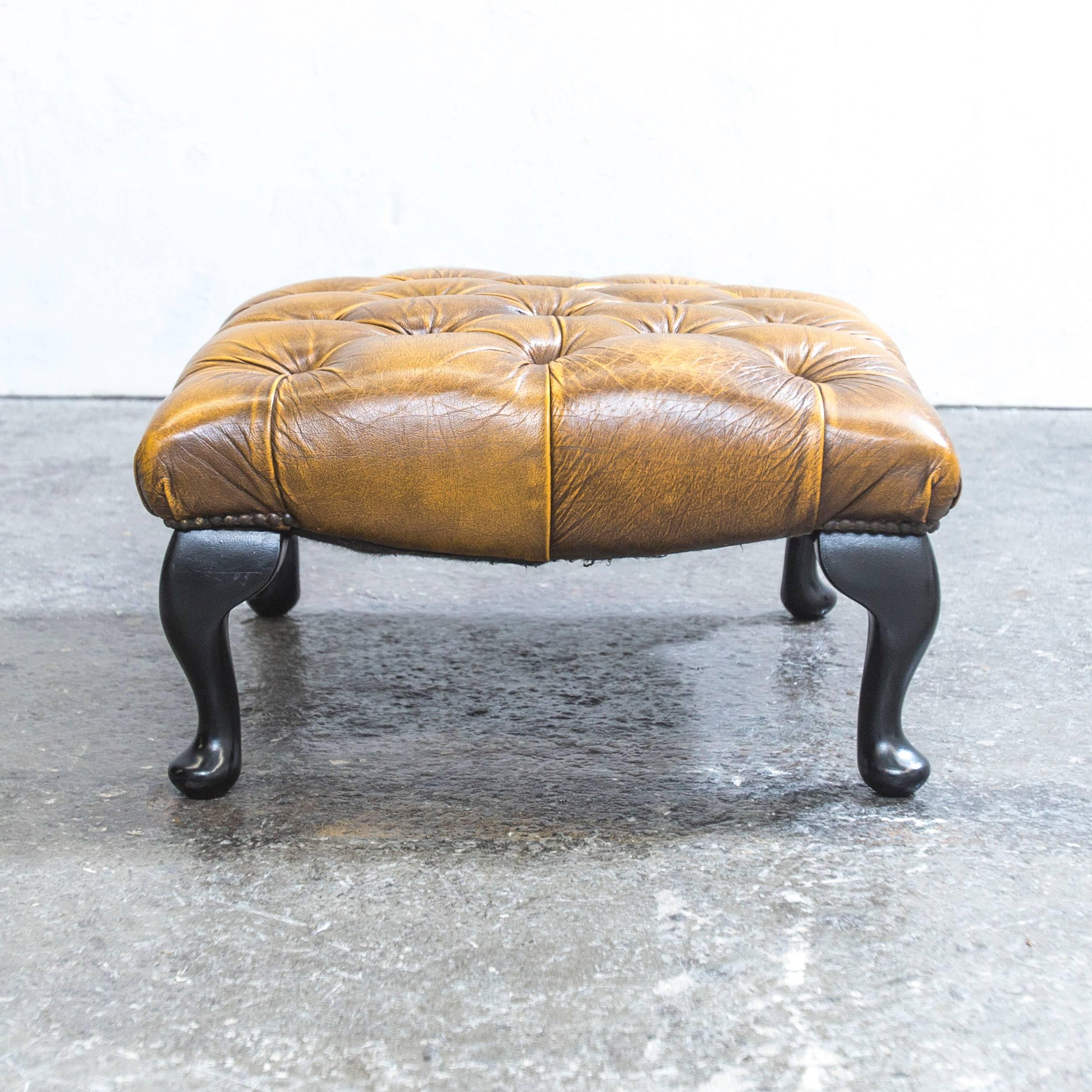 Ocher brown colored Chesterfield leather footstool in a vintage design, made for pure comfort and flexible placing.