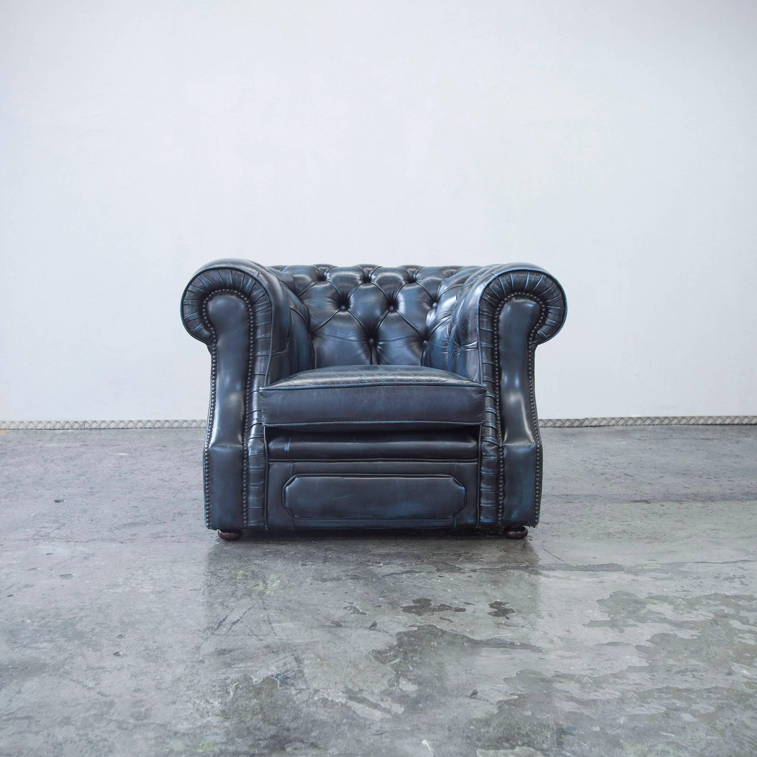 Blue colored original Chesterfield leather chair in a vintage design, made for pure comfort and elegance.