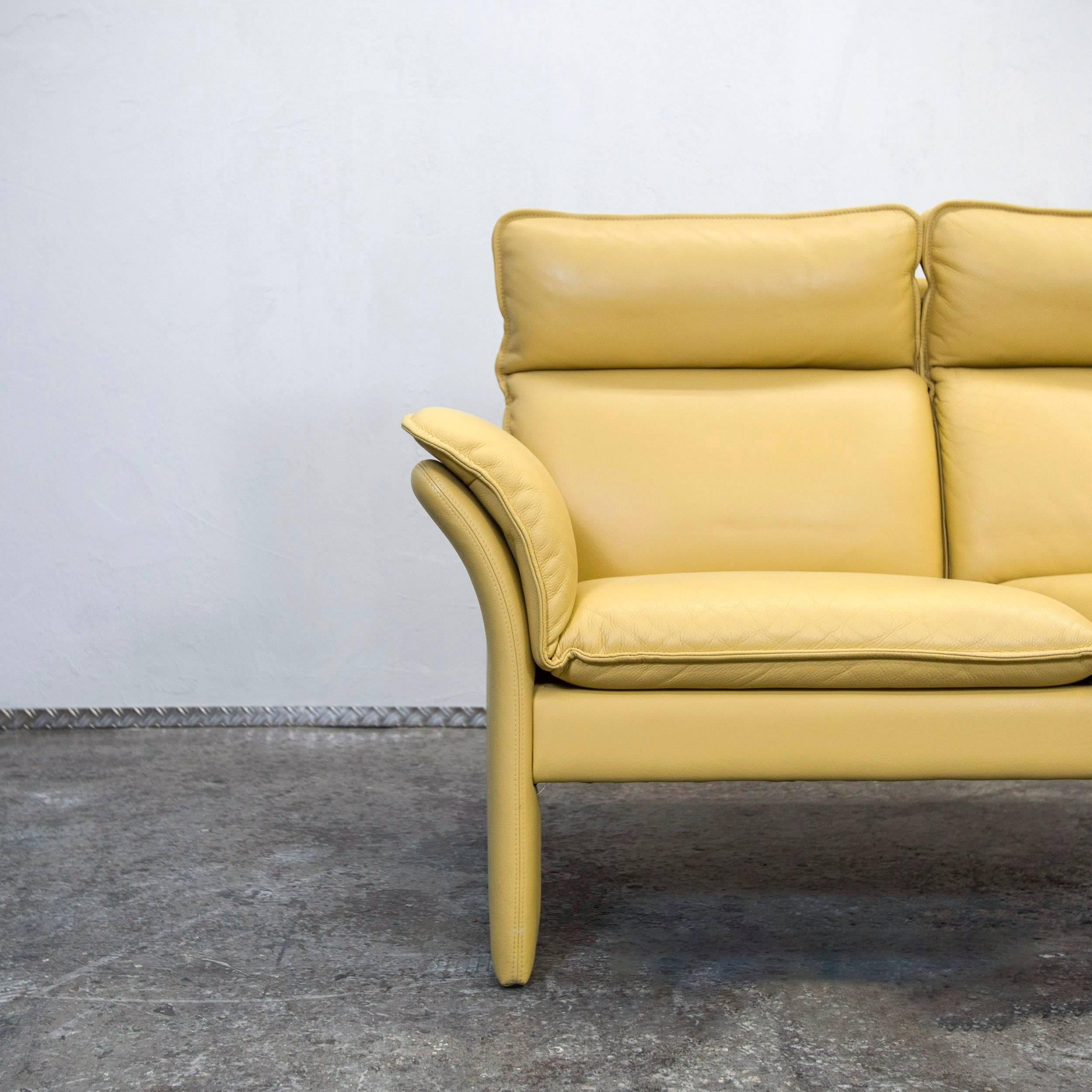 Mustard yellow colored original Dreipunkt designer leather sofa in a modern design, made for pure comfort.