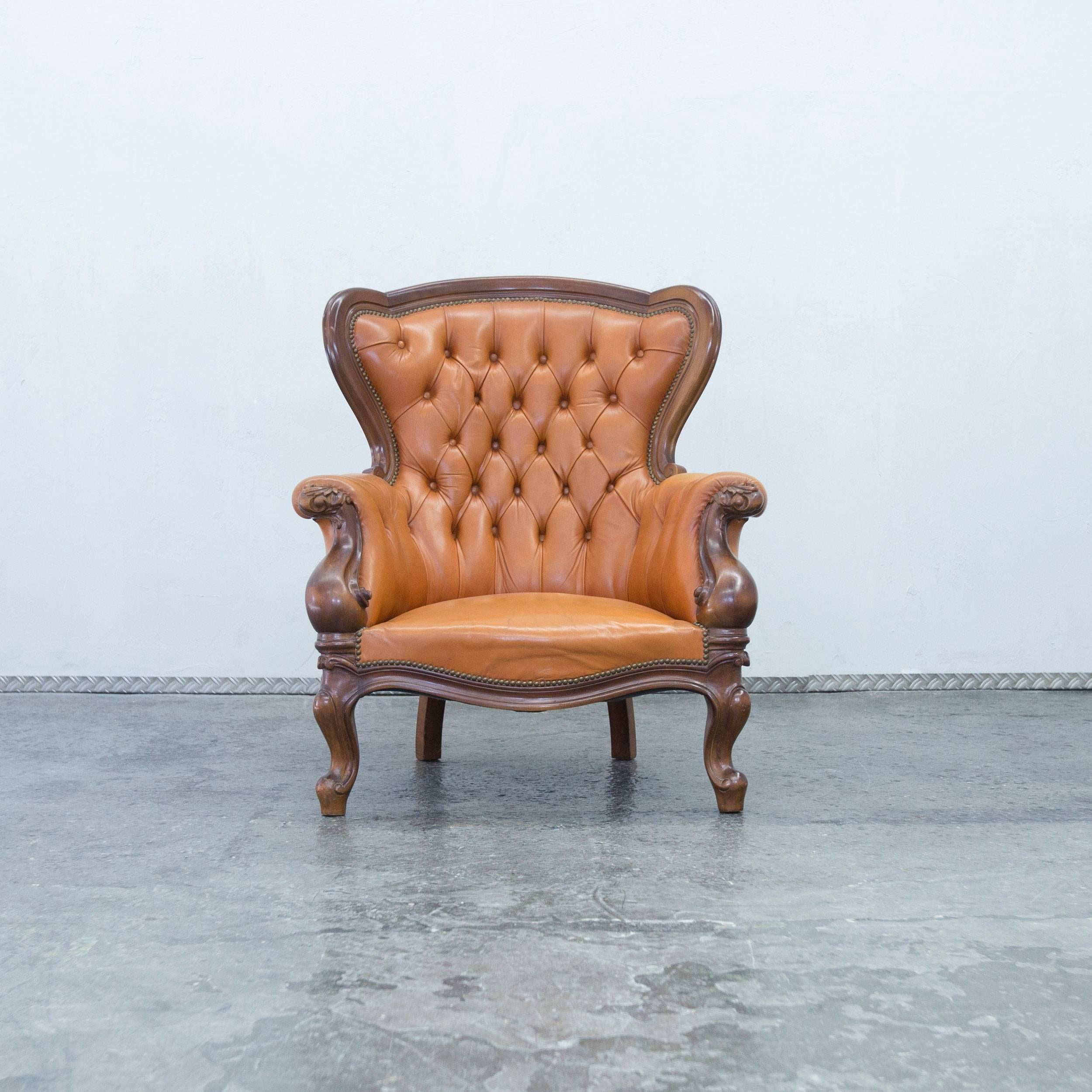Orange brown colored Chesterfield leather armchair in a vintage design, made for pure comfort and elegance.