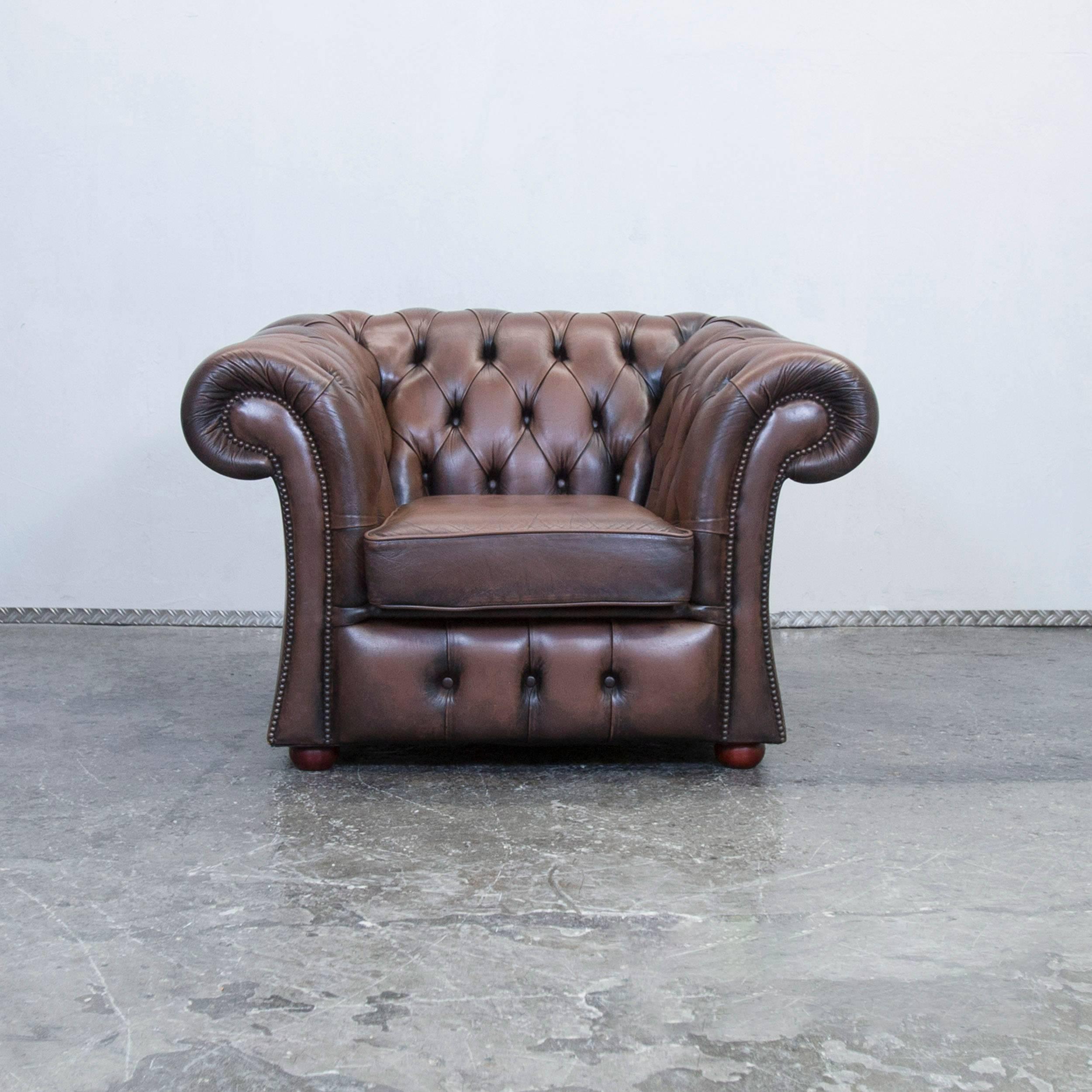 Brown colored Chesterfield leather armchair in a vintage design, made for pure comfort and elegance.