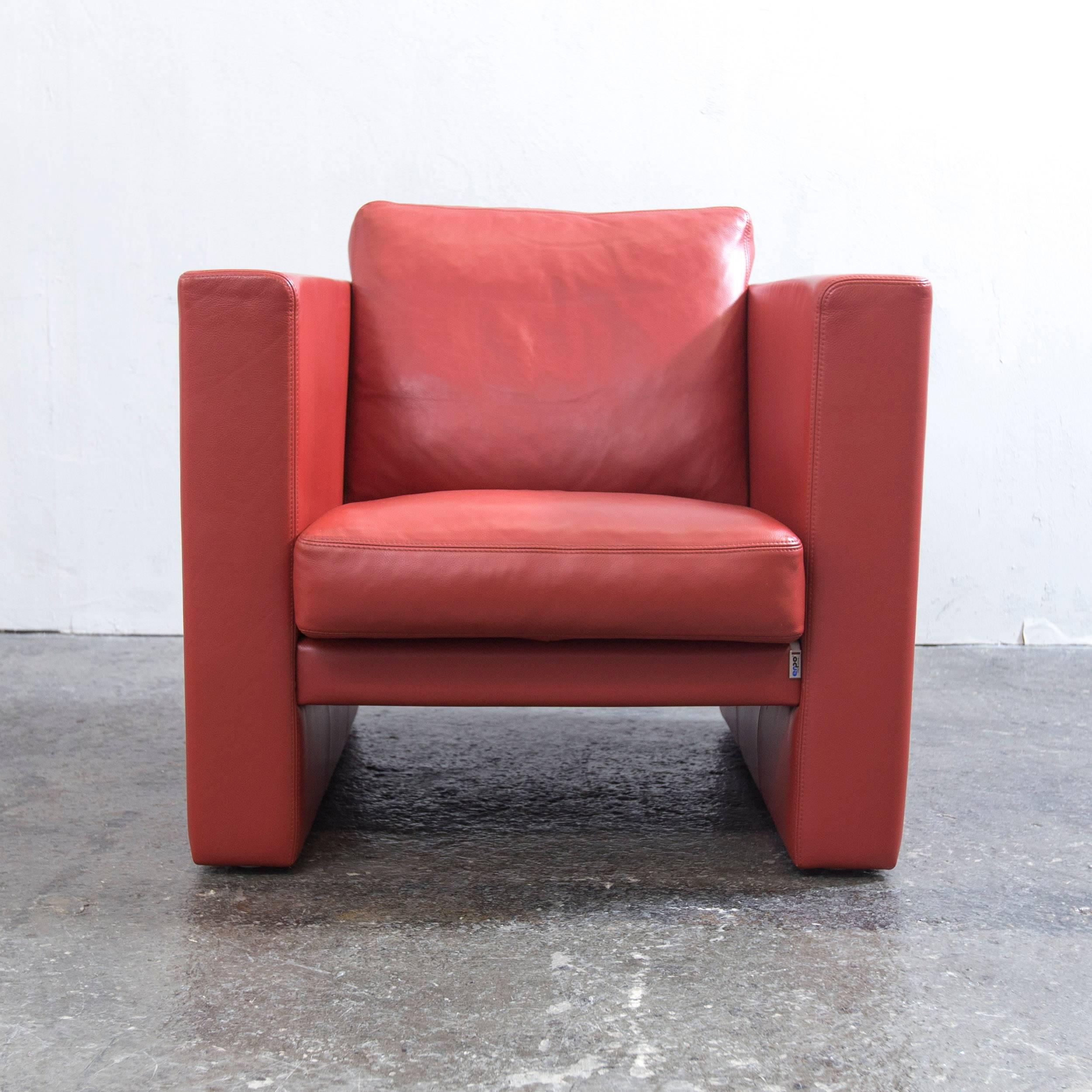 Orange red colored original Erpo designer leather armchair in a minimalistic and modern design, made for pure comfort.