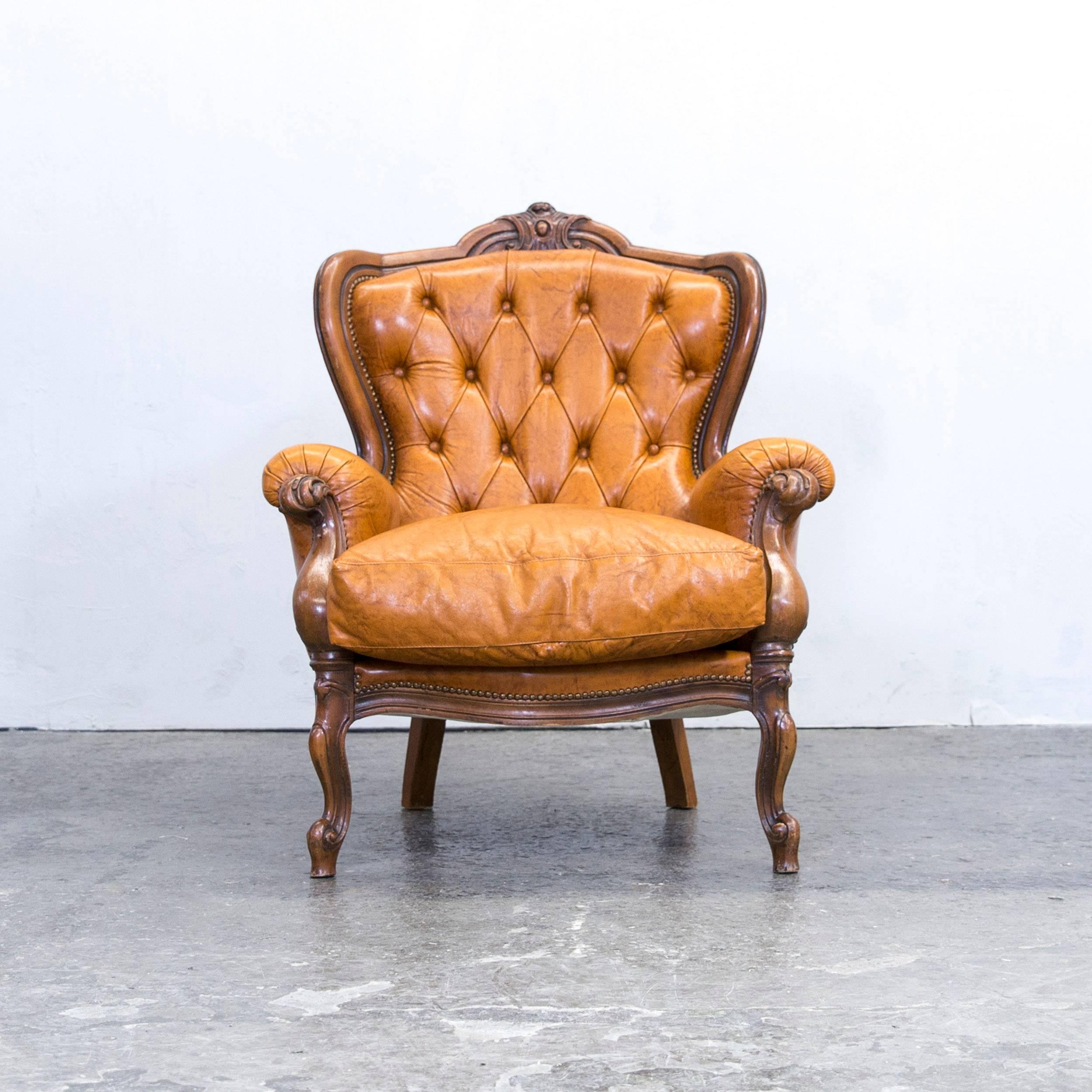 Cognac brown colored original Chesterfield leather armchair in a vintage design, made for pure comfort and elegance.