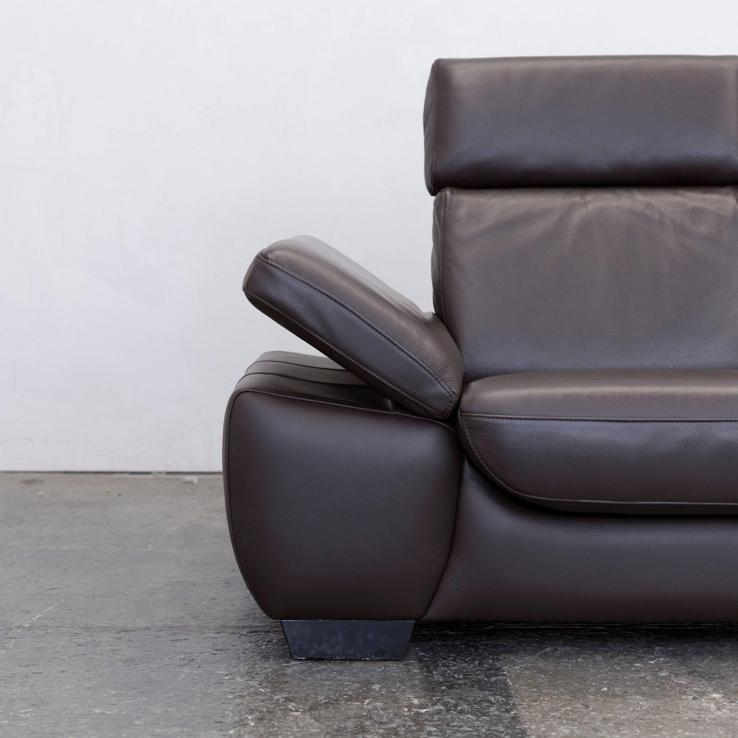 Modern leather two-seat couch in brown with recline function.