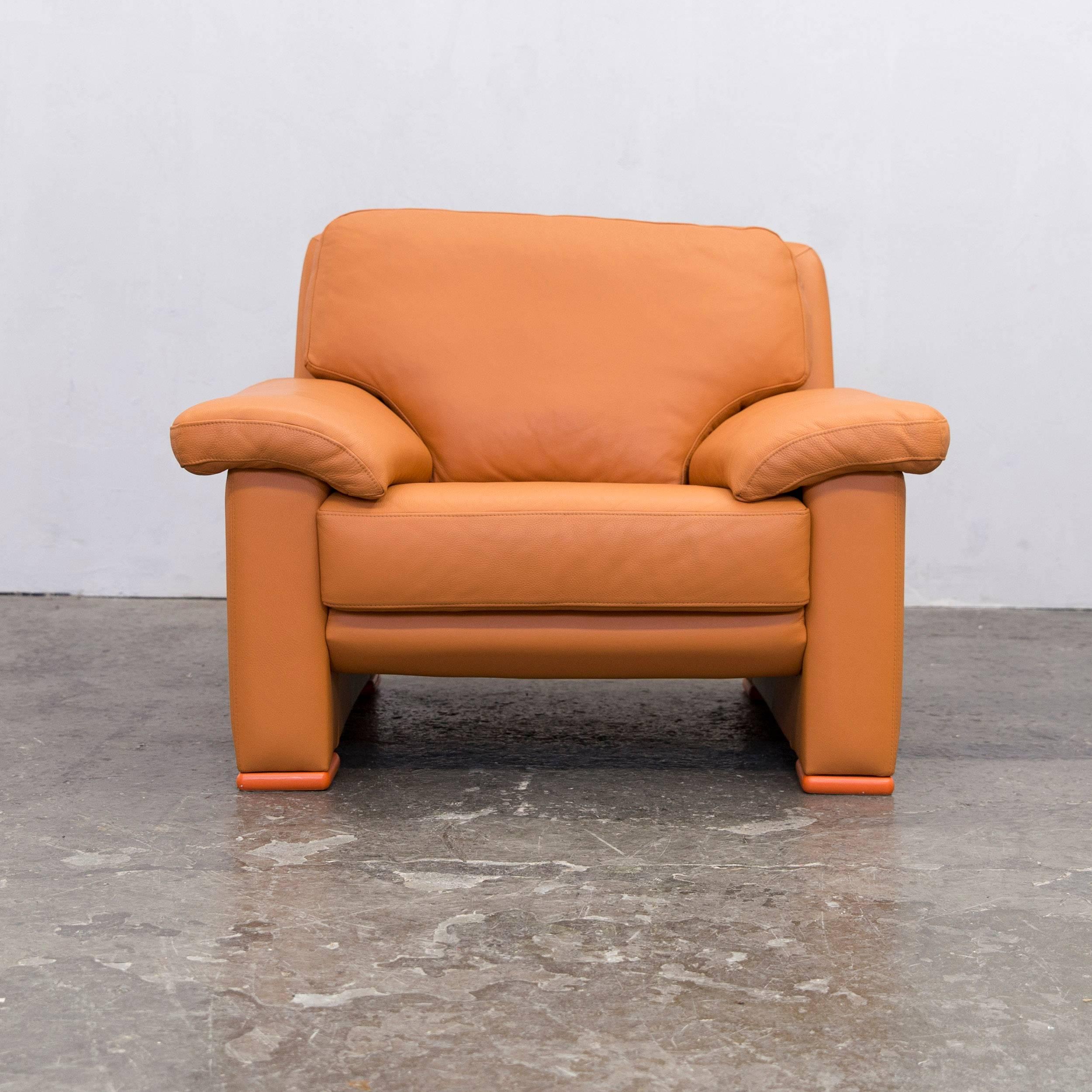 Orange colored designer leather chair in a minimalistic design, made for pure comfort.
Desgined and manufactured by Willi Schillig.