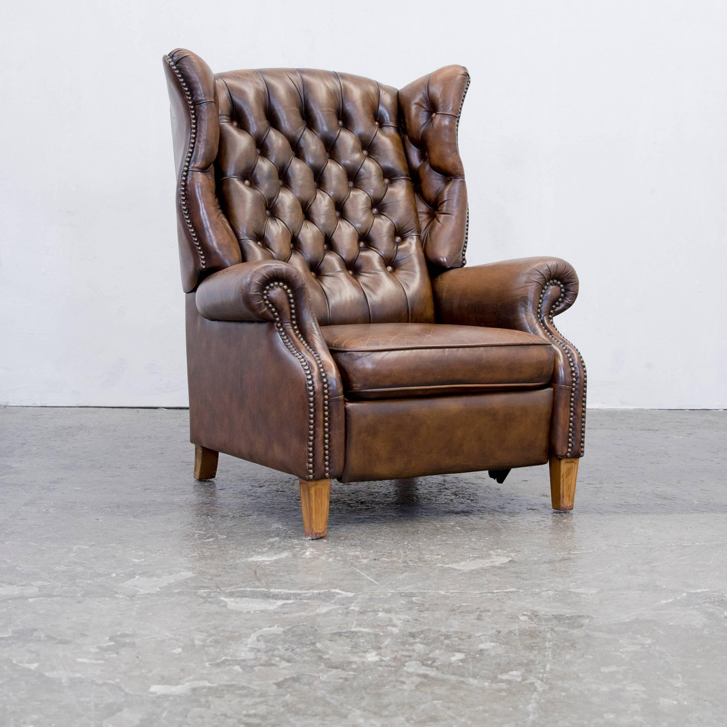 Authentic leather armchair with recline funktion in brown.