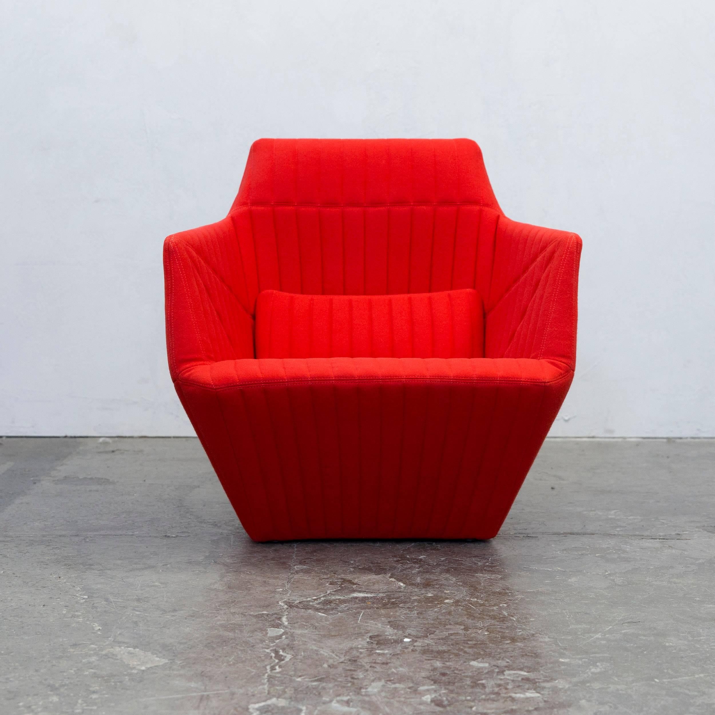 Red colored original Ligne Roset Facett chair, designed by R. & E. Bourroullec, in a minimalistic and modern design.