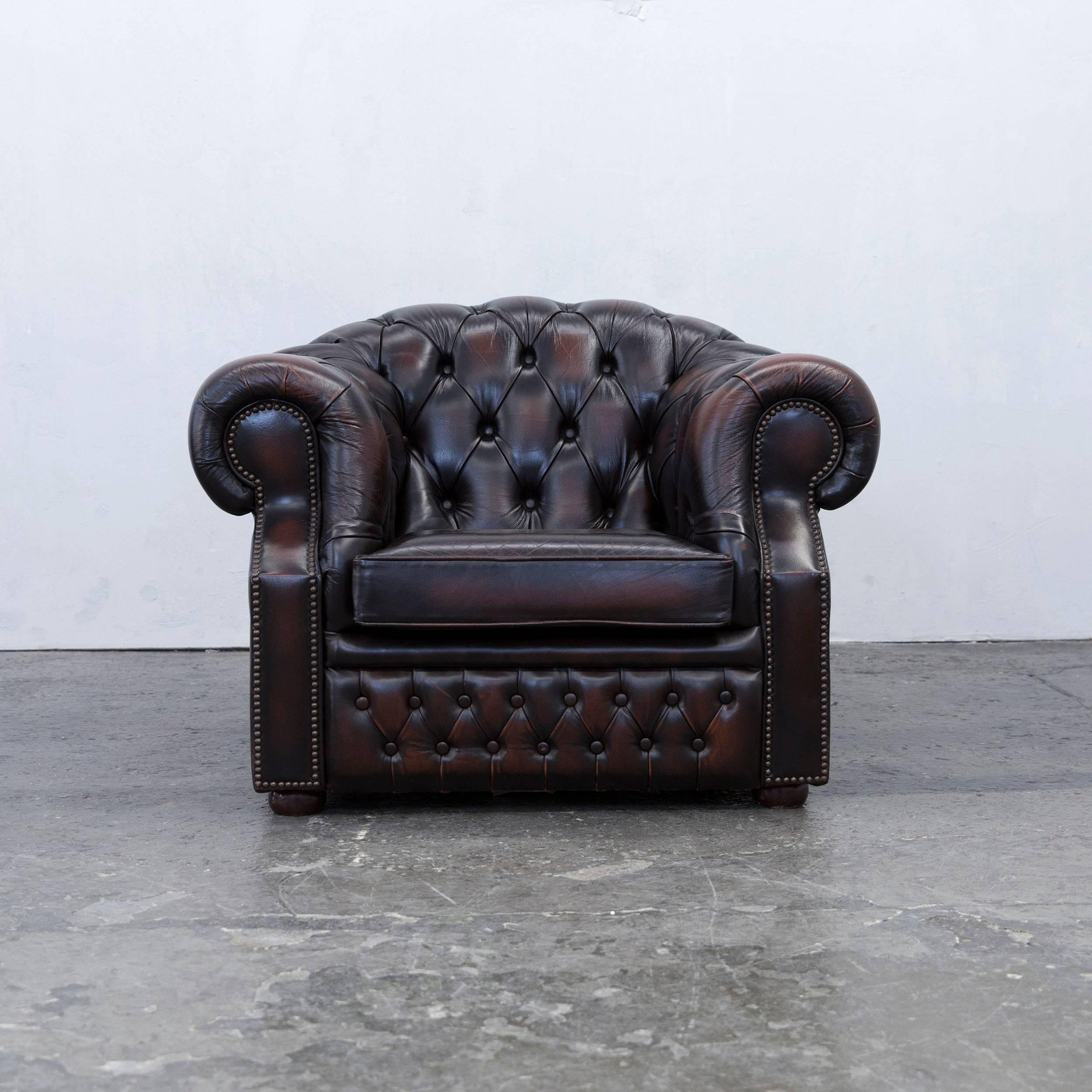 Brown colored original Chesterfield leather armchair in a vintage design, made for pure comfort and elegance.