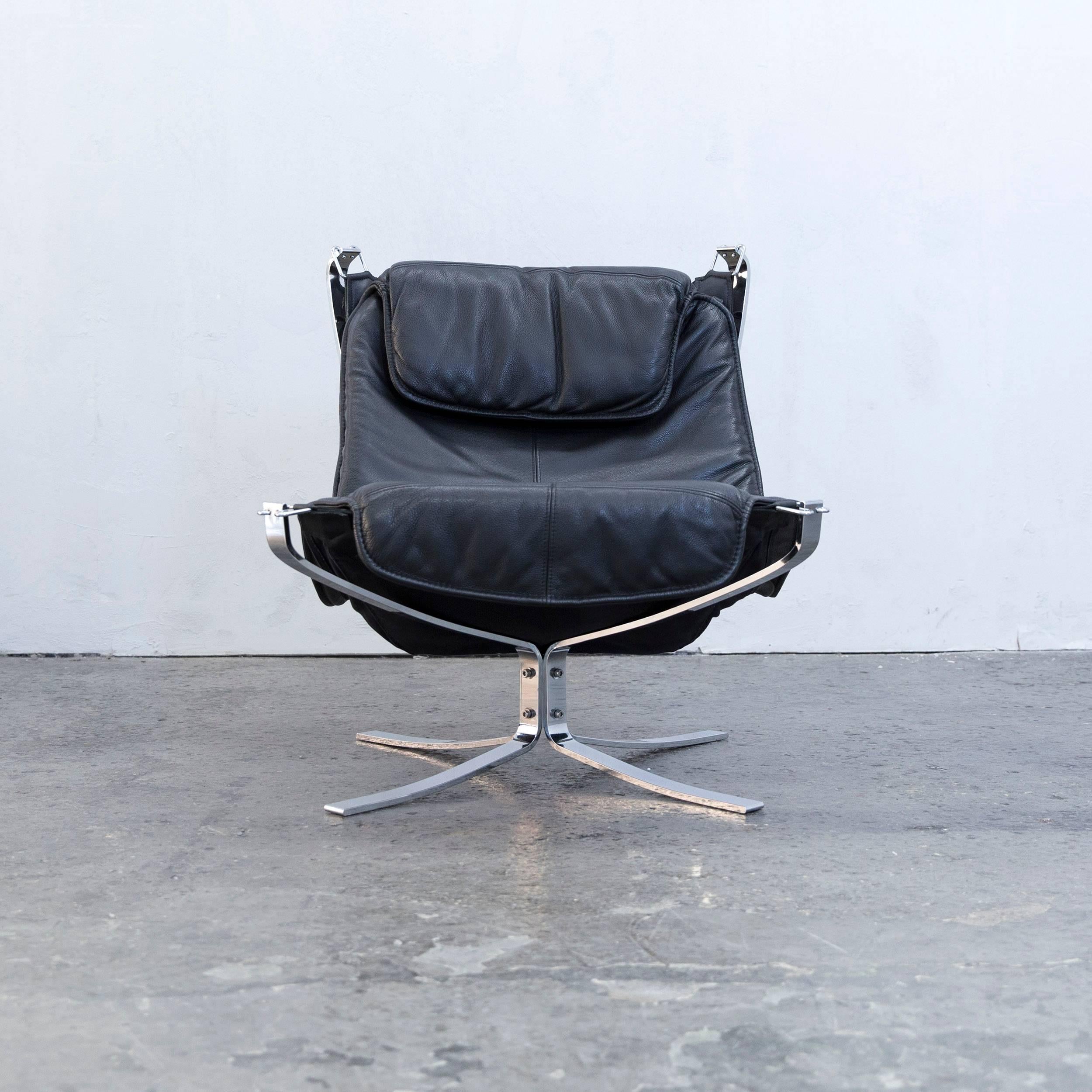 Black colored original Sigurd Resell Falcon leather chair and footstool in a minimalistic and modern design, made for pure comfort and style.