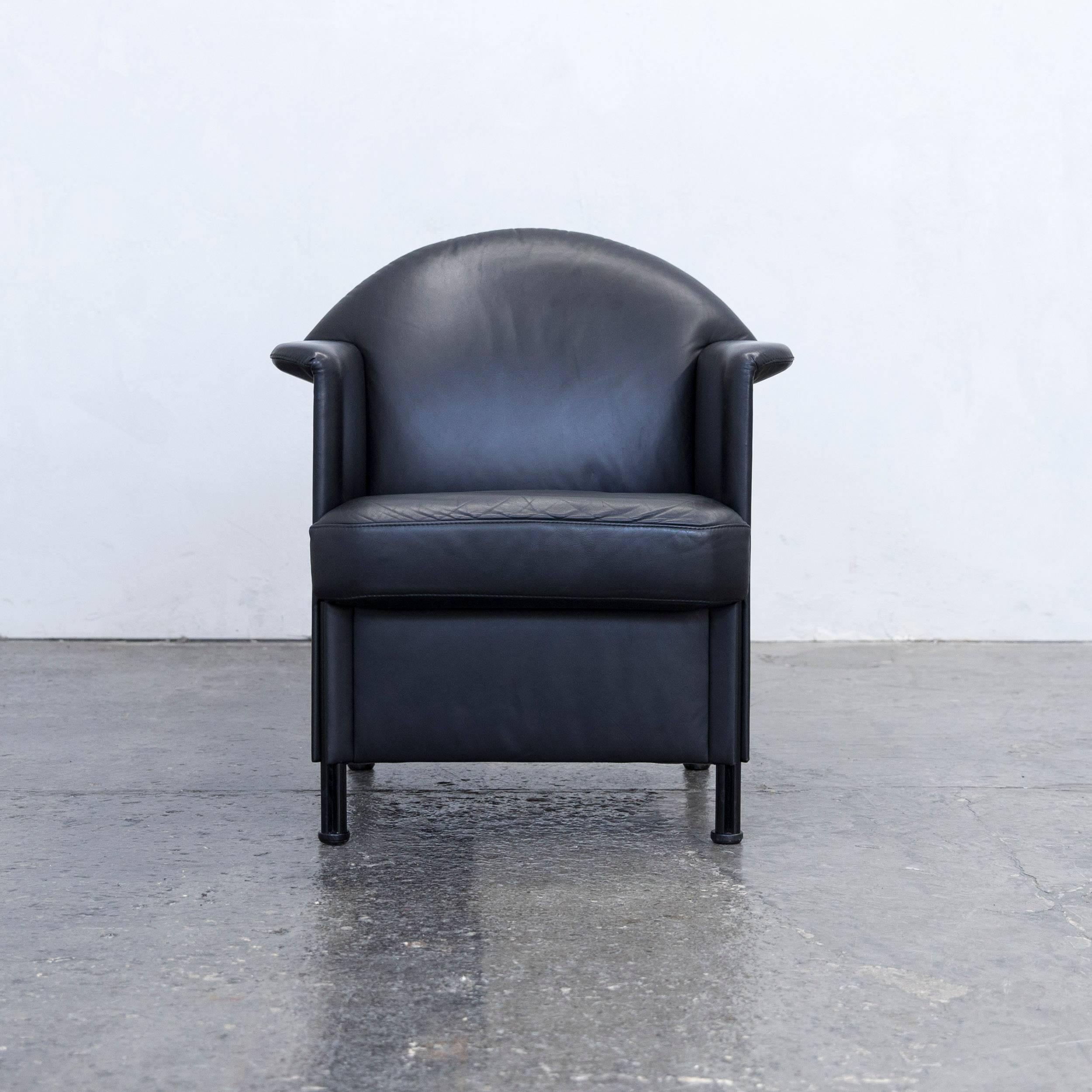 Black colored original COR designer leather armchair in a minimalistic and modern design, made for pure comfort.