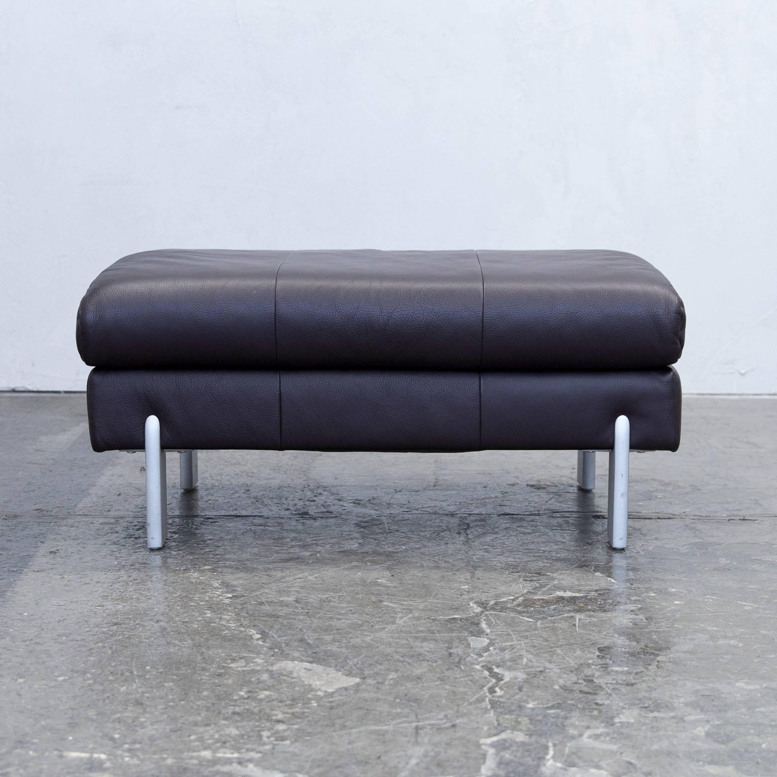 Aubergine colored original Rolf Benz designer leather footstool in a minimalistic and modern design, made for pure comfort and flexible placing.