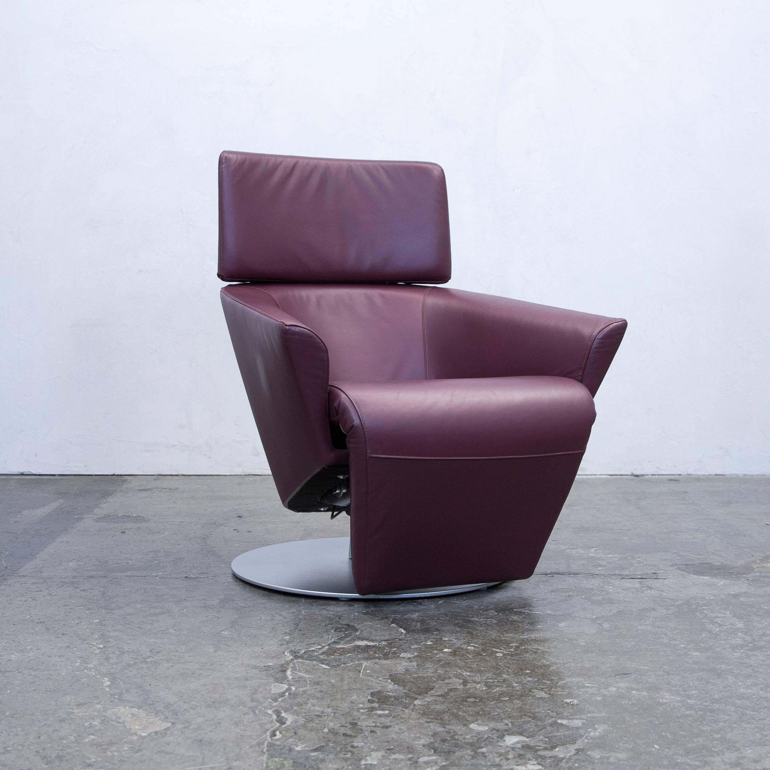 Aubergine colored original WK Wohnen designer leather armchair in a minimalistic and modern design, with a convenient electrical function, made for pure comfort and flexibility.