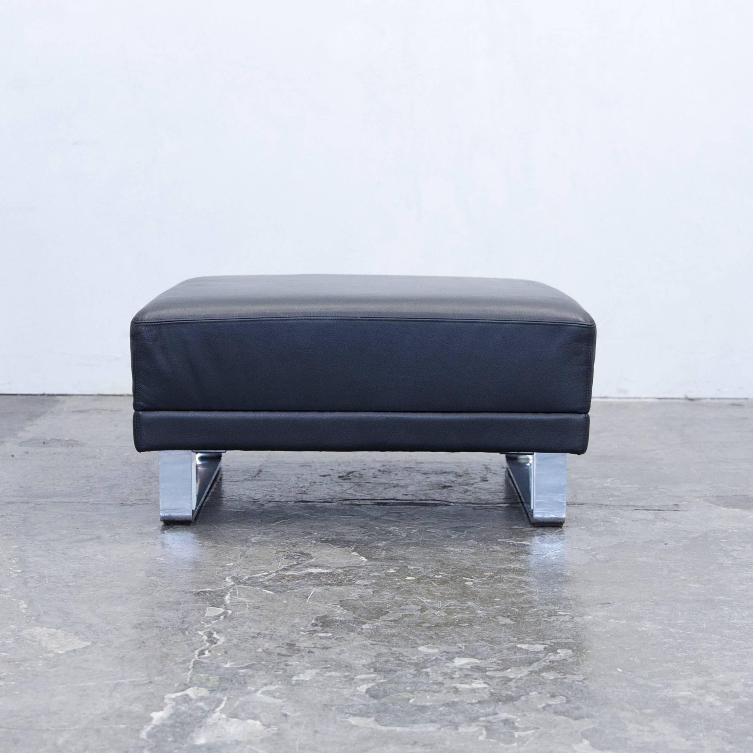 Black colored original Brühl Alba designer leather footstool in a minimalistic and modern design, made for pure comfort and flexible placing.