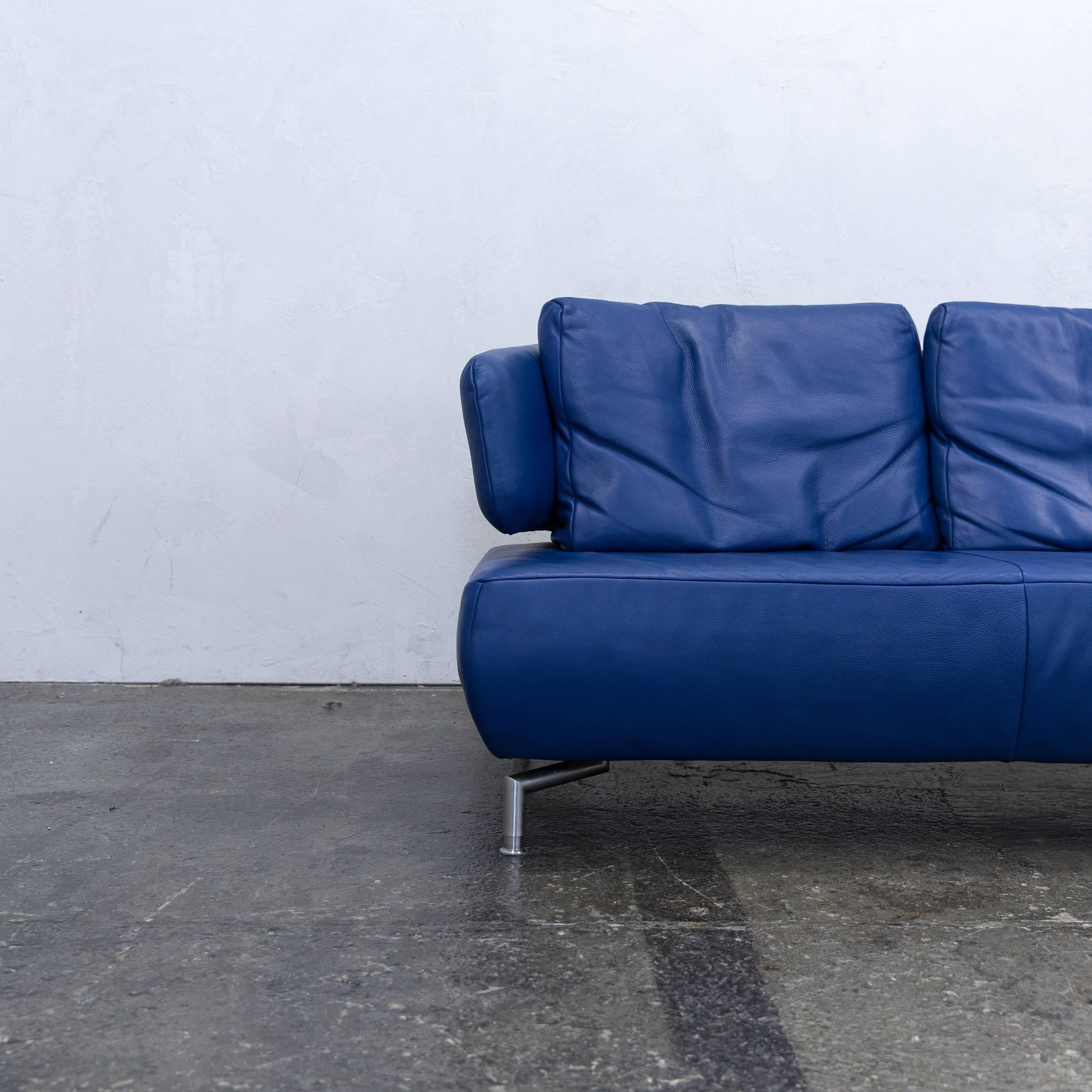 Blue colored original Koinor designer leather sofa in a minimalistic and modern design, with a convenient function, made for pure comfort and flexibility.