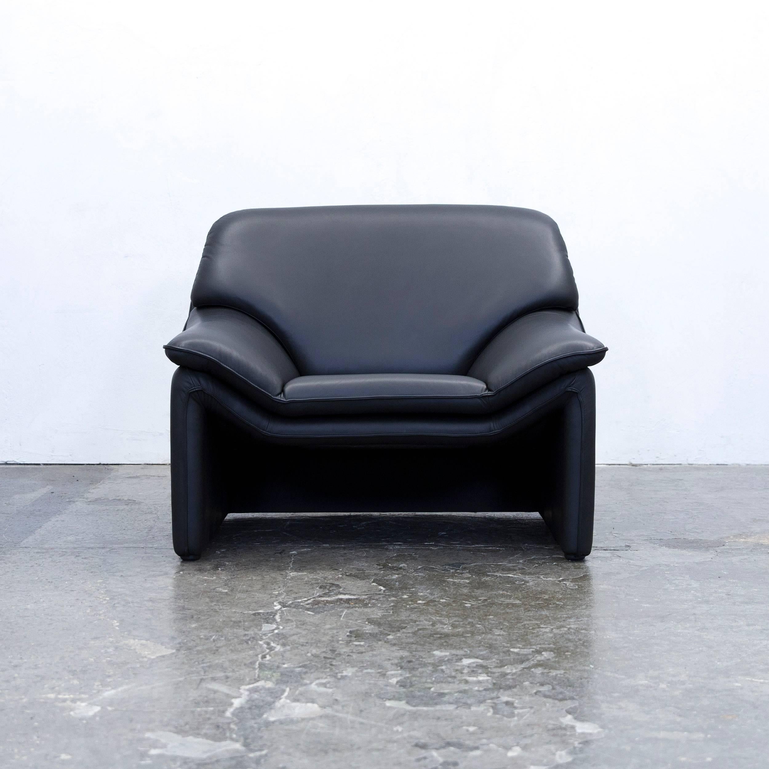 Black colored original Laauser Atlanta designer leather armchair in a minimalistic and modern design.