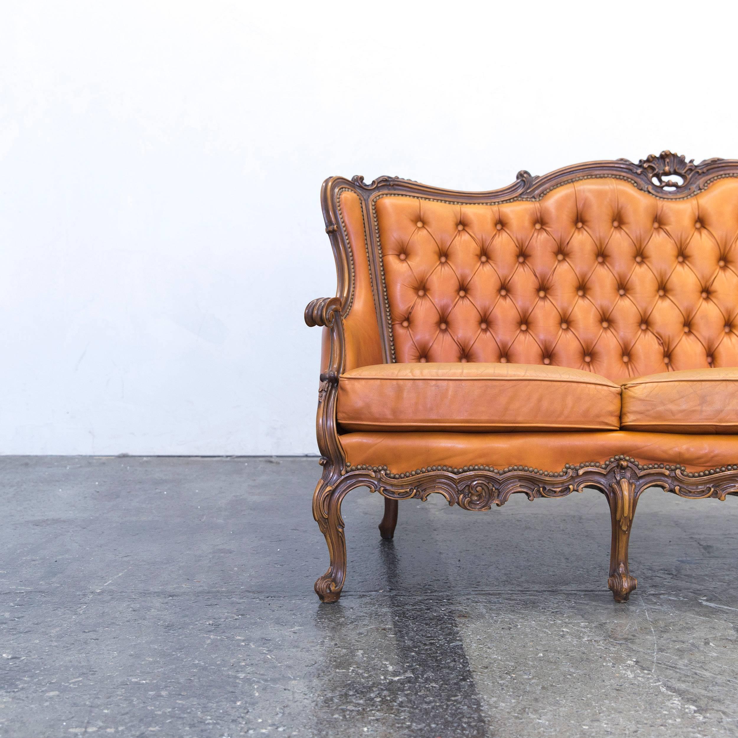 Cognac brown colored original Chesterfield leather sofa in a vintage design, made for pure comfort and elegance.
