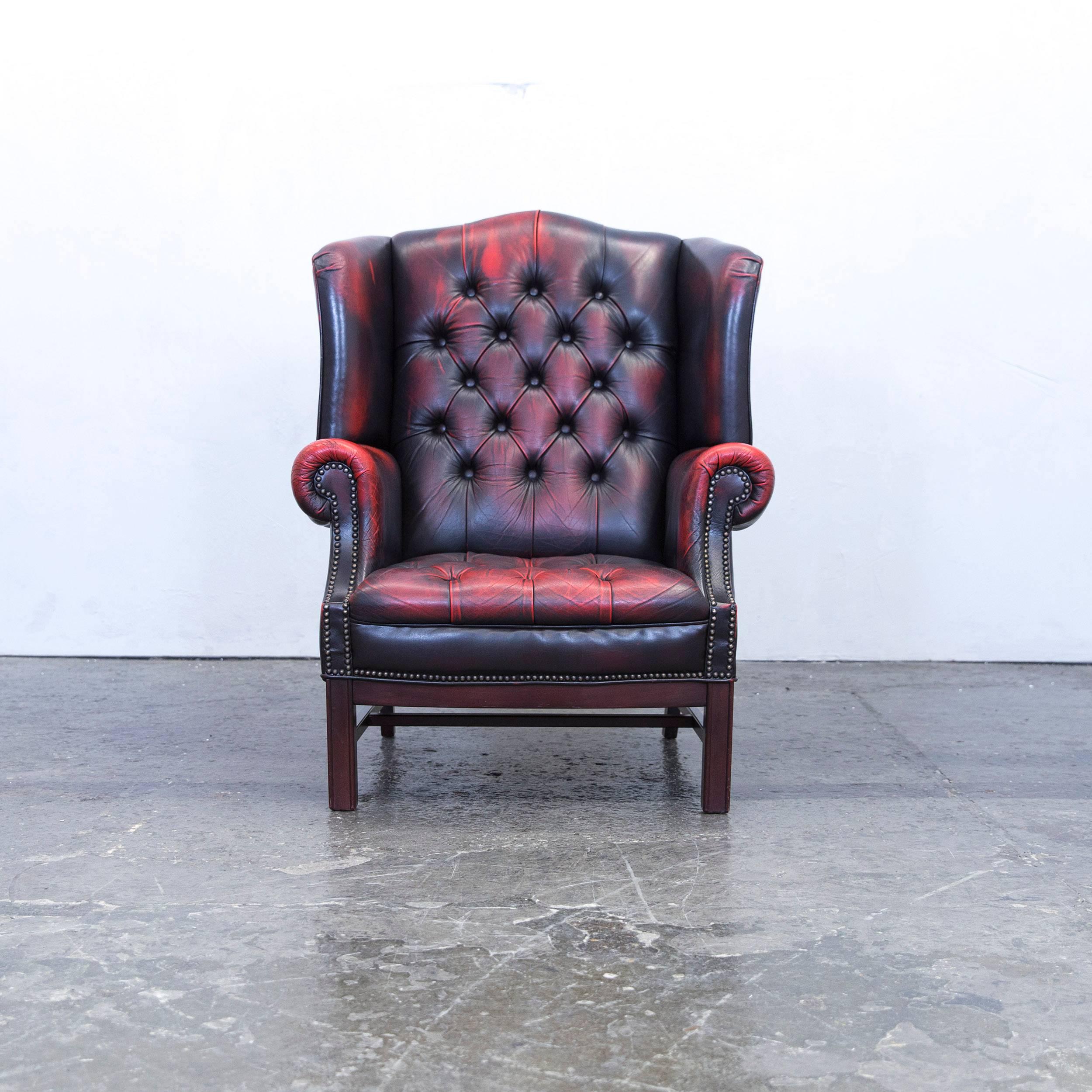 Red brown colored Chesterfield leather armchair in a vintage design, made for pure comfort and elegance.