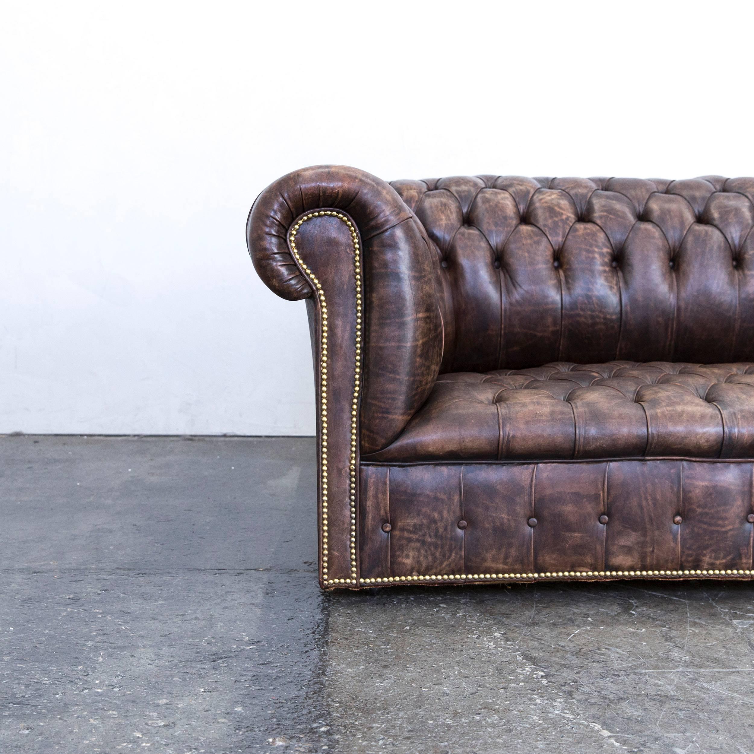 Brown colored Chesterfield leather sofa in a vintage design, made for pure comfort and elegance.