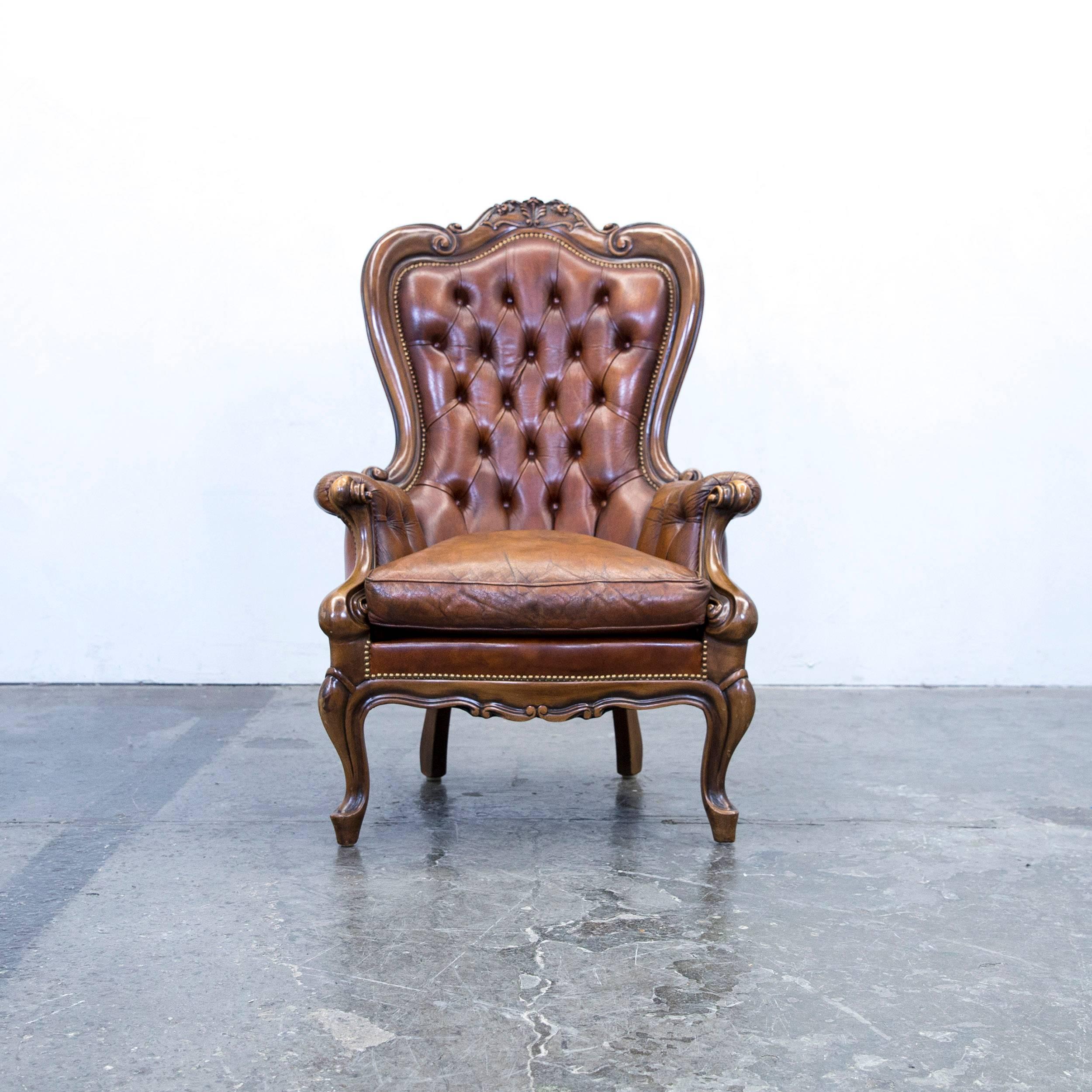 Brown colored original Chesterfield leather armchair, in a vintage design, made for pure comfort.