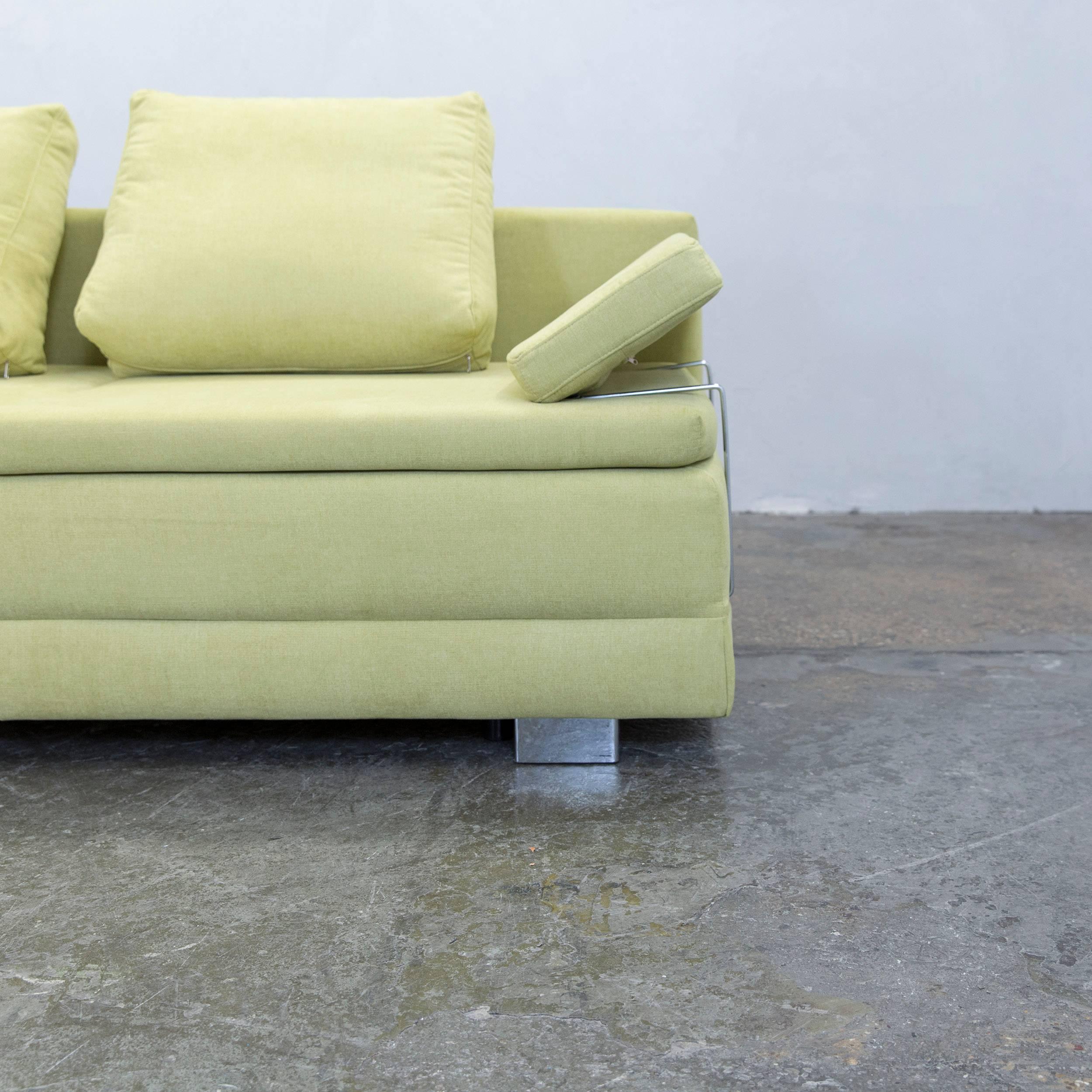 Green colored designer sleep sofa, in a minimalistic and modern design, with a convenient function, made for pure comfort and flexibility.