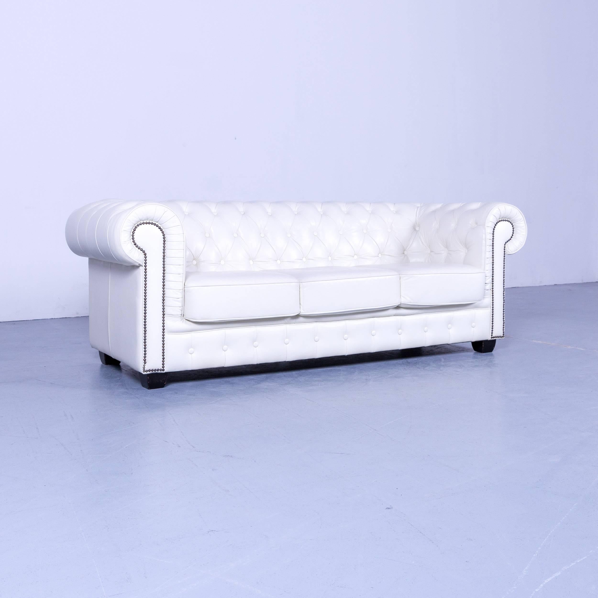 Chesterfield three-seat sofa set of two white leather couch vintage retro rivets, made for pure comfort and elegance.