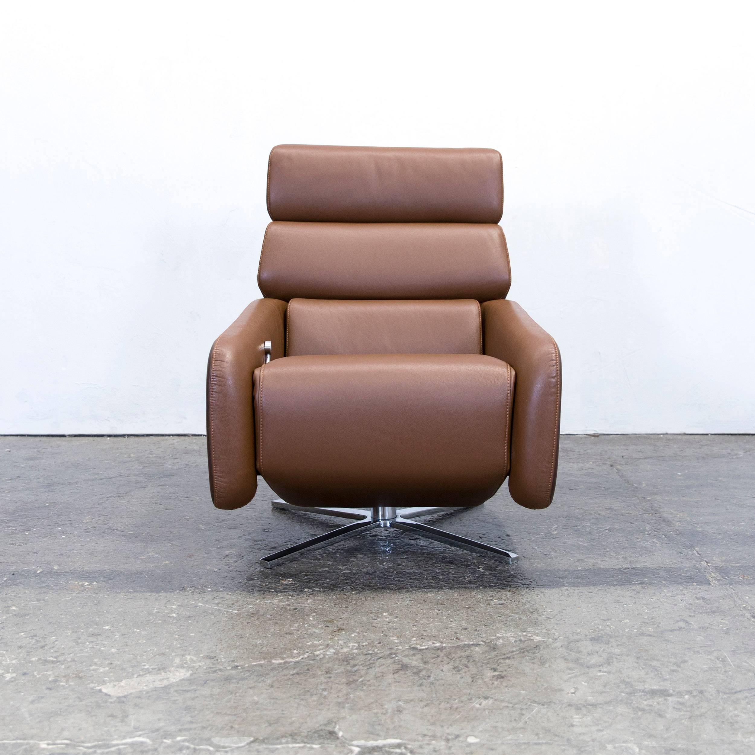 Brown colored original FSM Ergo designer leather armchair, in a minimalistic and modern design, with convenient functions, made for pure comfort and flexibility.