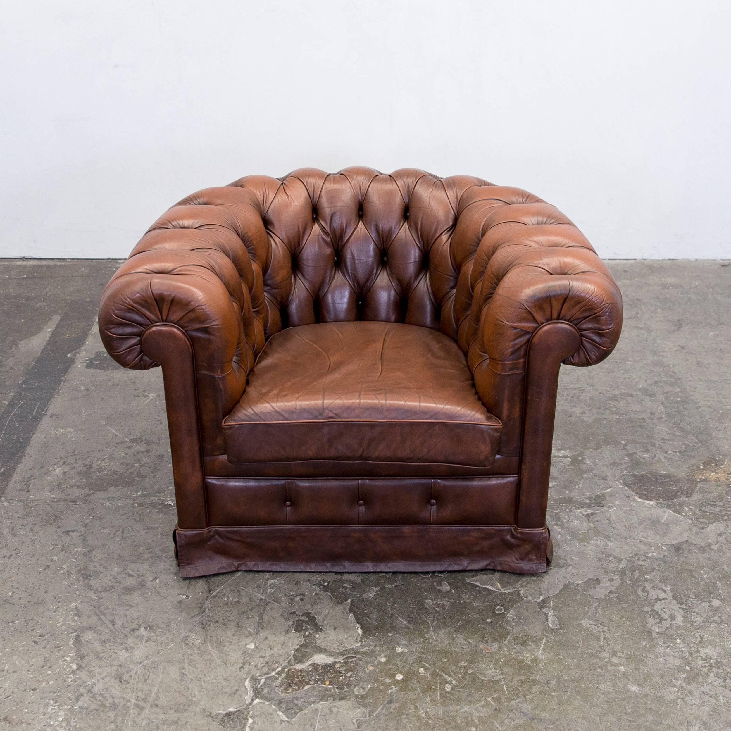 Original Chesterfield armchair in authentic brown leather.