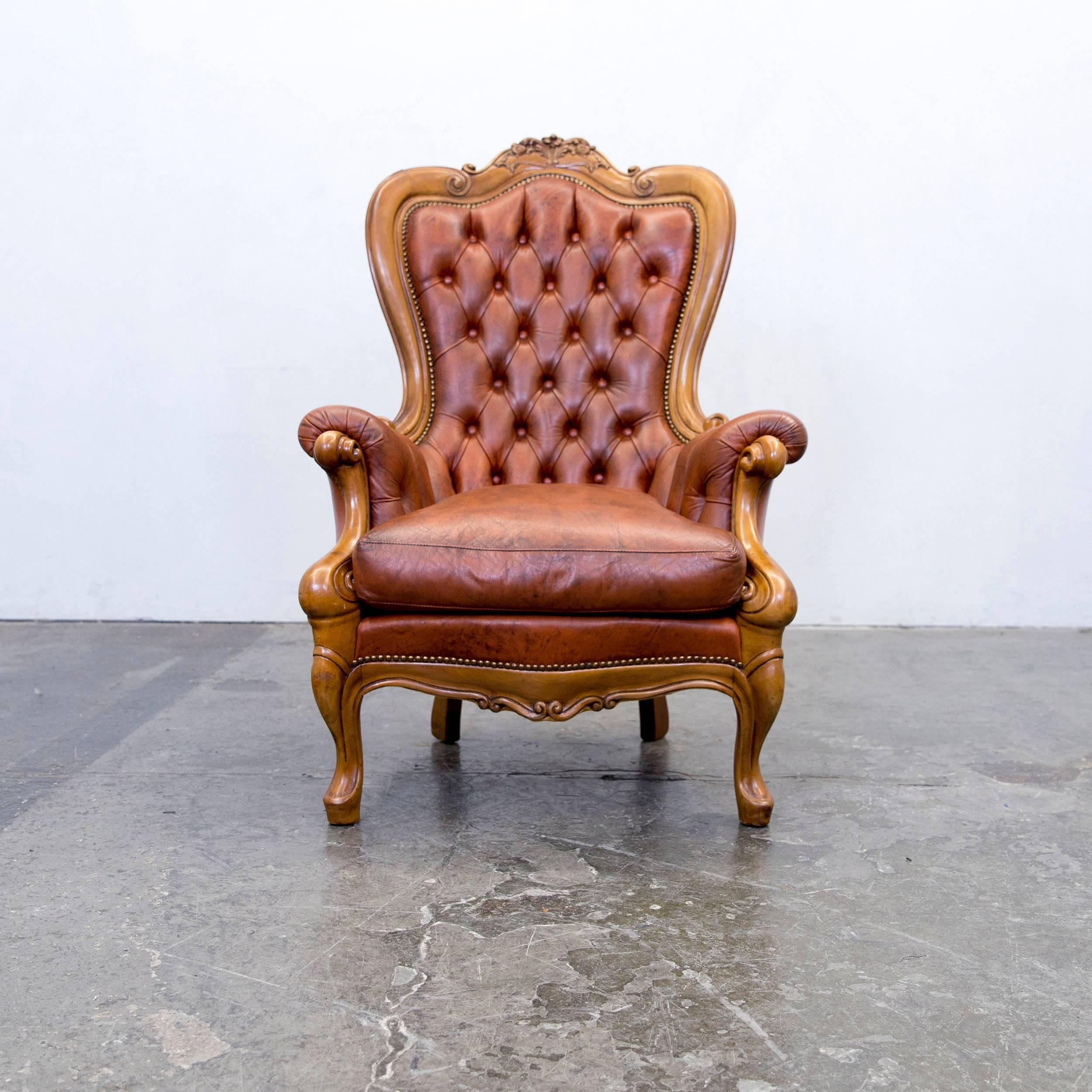 Brown colored original Chesterfield leather armchair, in a vintage design, made for pure comfort.