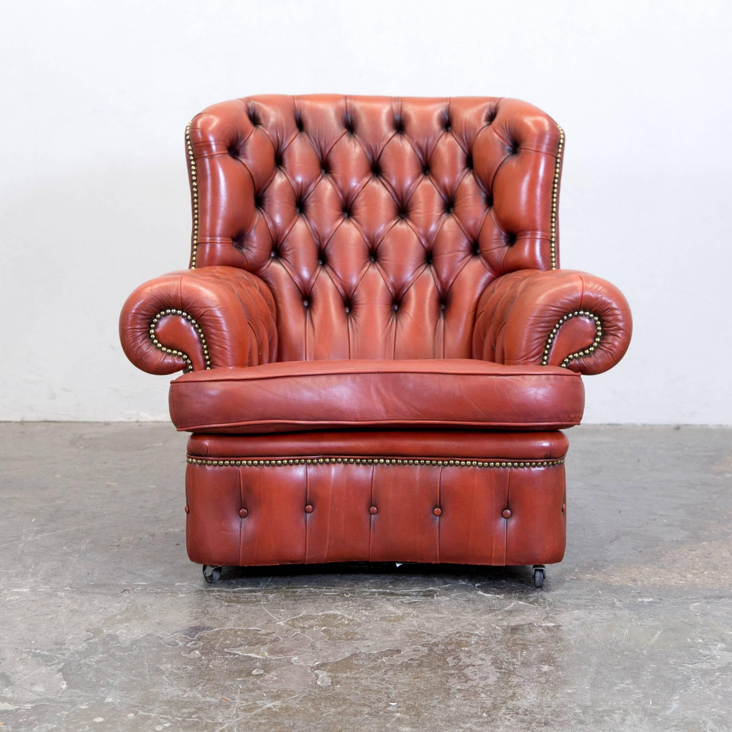 Chesterfield leather brown orange one seat vintage retro rivets armchair, in a vintage design, made for pure comfort.