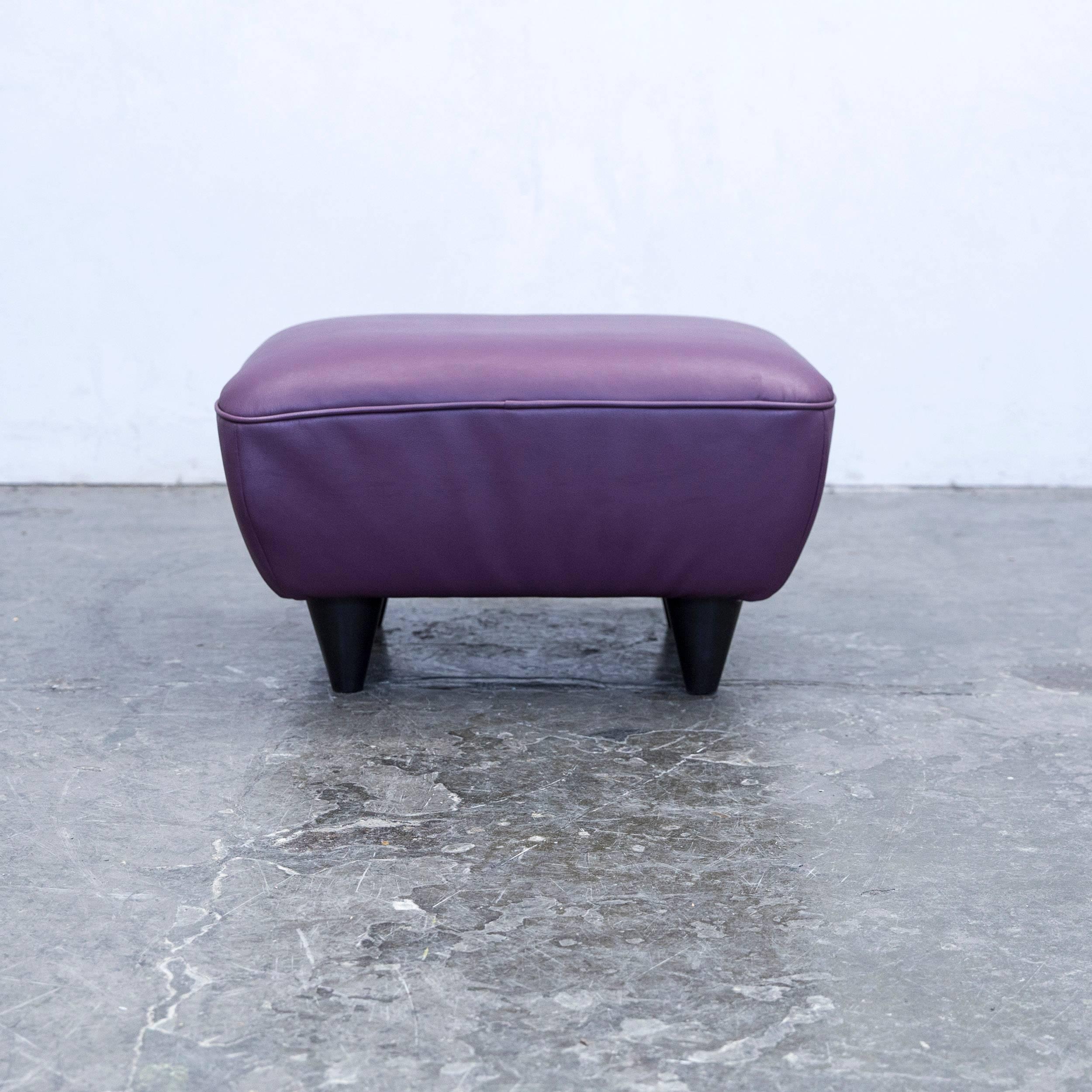 Lilac colored designer footstool, in a minimalistic and modern design, made for pure comfort and style.