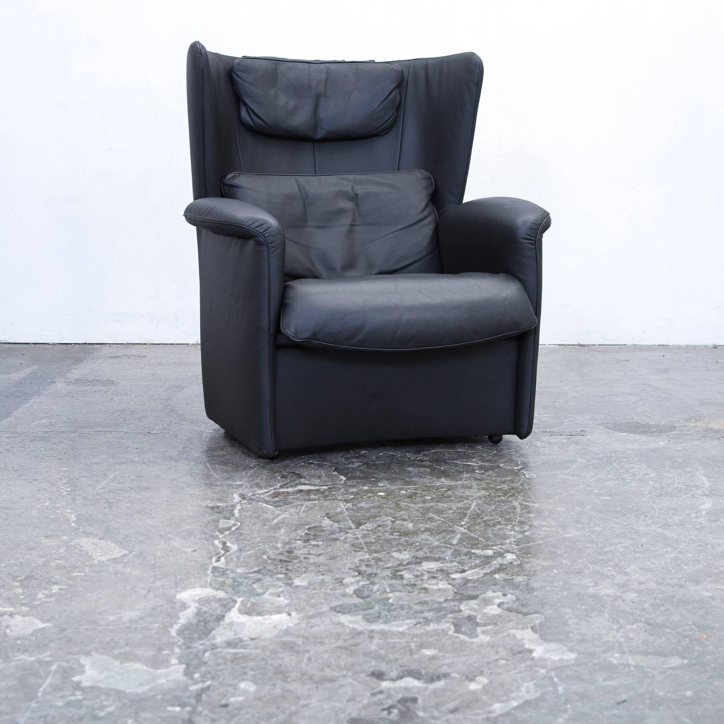 Black colored original De Sede DS 23 designer leather armchair and footrest, in a minimalistic and modern design, made for pure comfort and style.