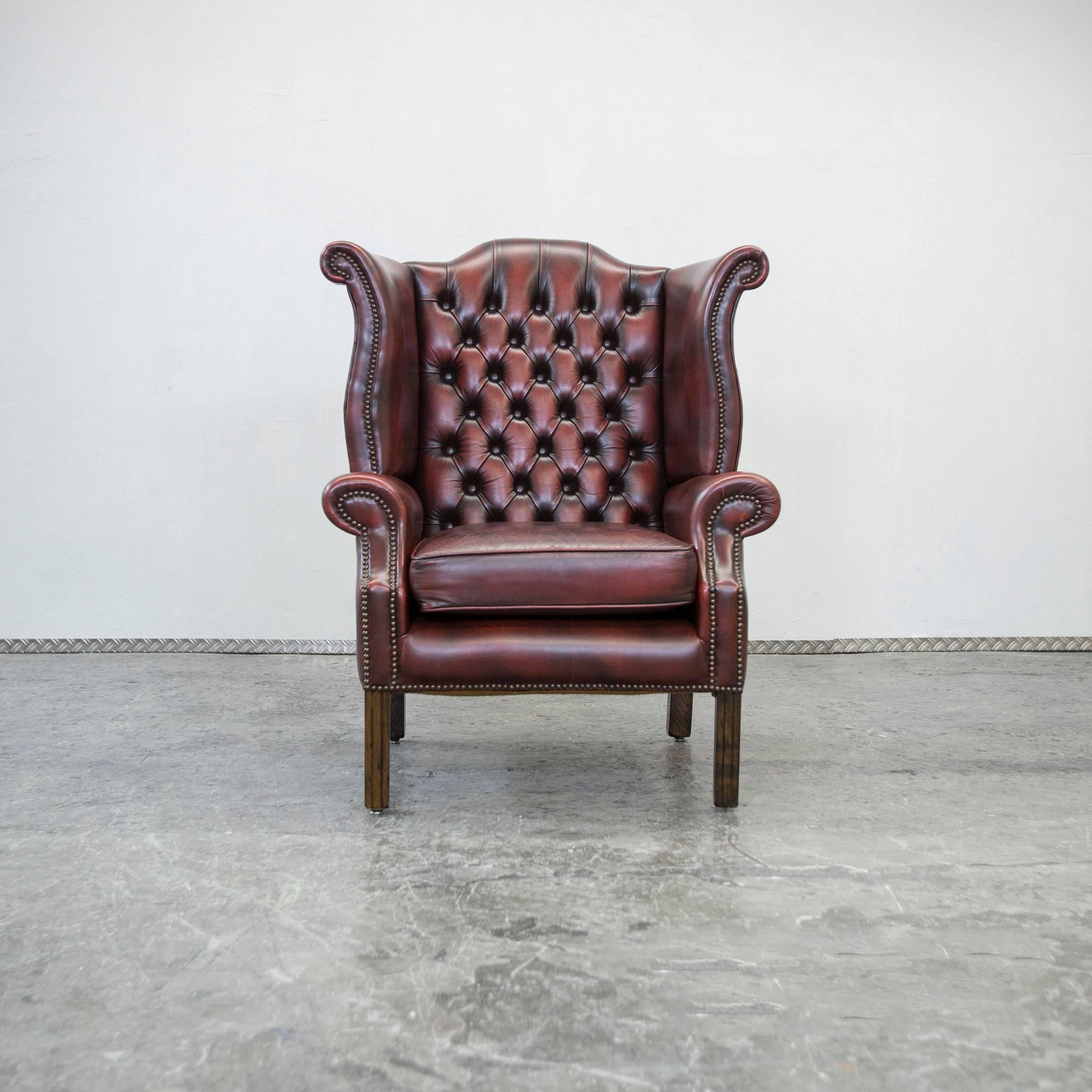 Oxblood red colored Chesterfield leather wingchair in a vintage design, made for pure elegance and comfort.