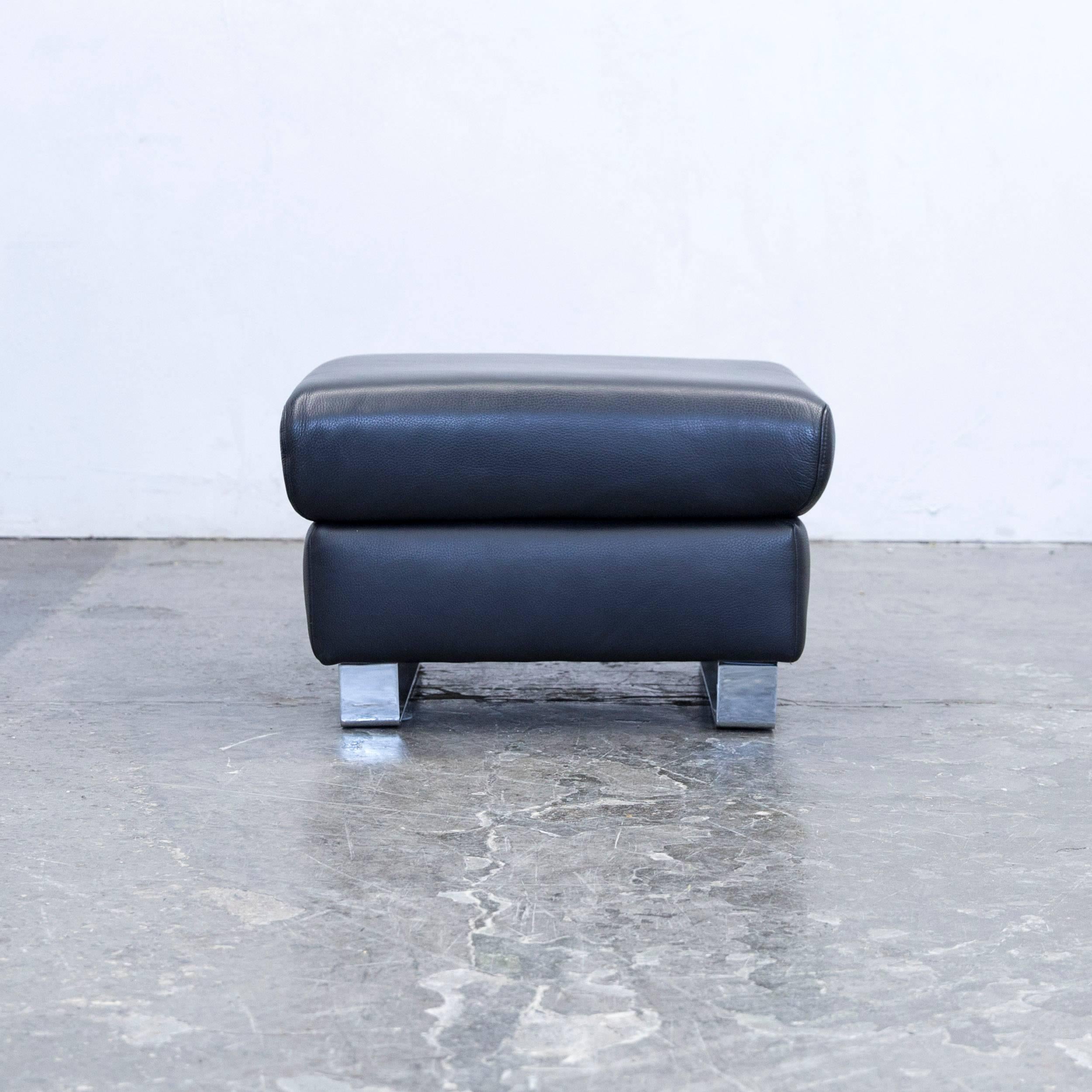 Black colored original Ewald Schillig Harry designer leather footstool, in a minimalistic and modern design, made for pure comfort.