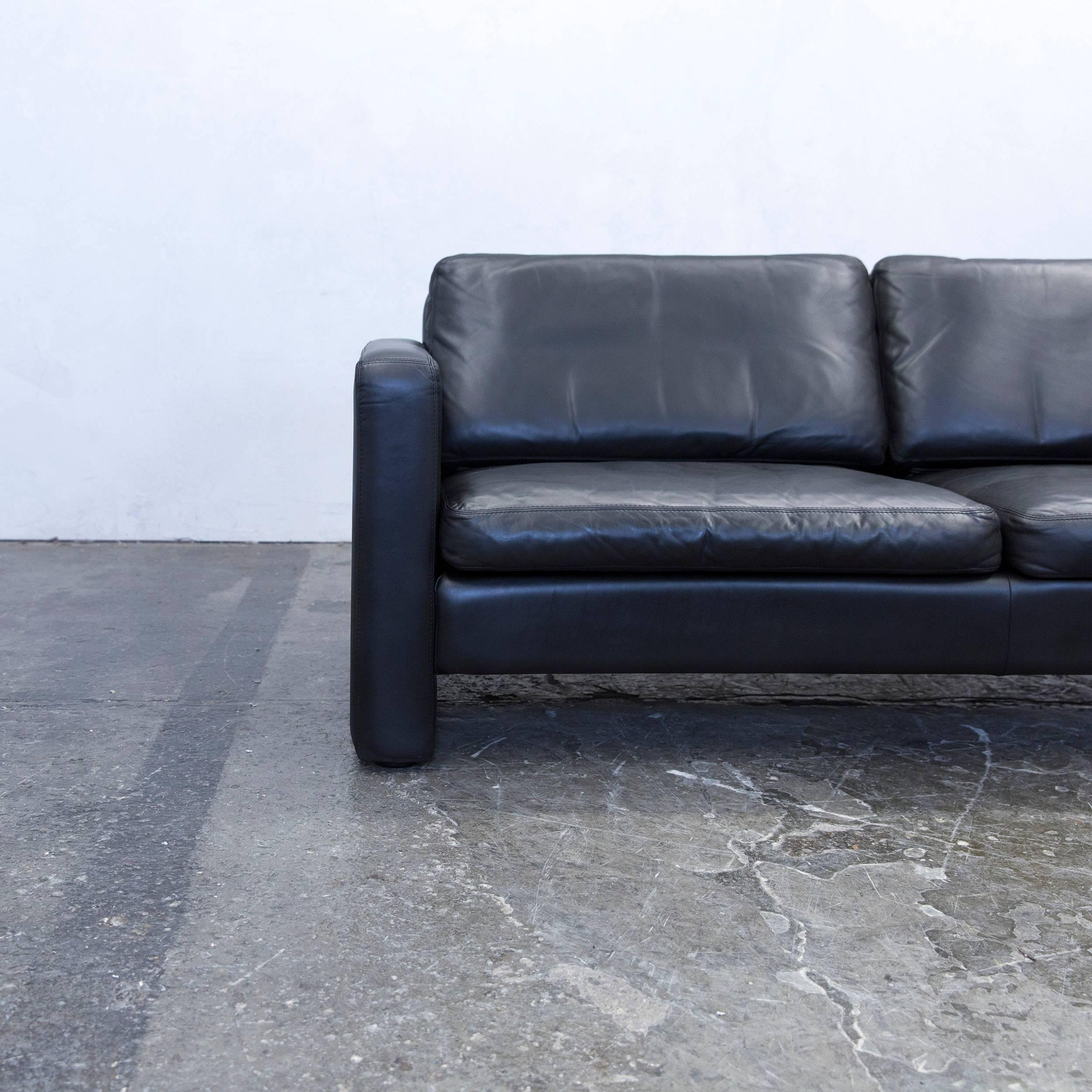 Black colored original COR designer leather sofa, in a minimalistic and modern design, made for pure comfort.