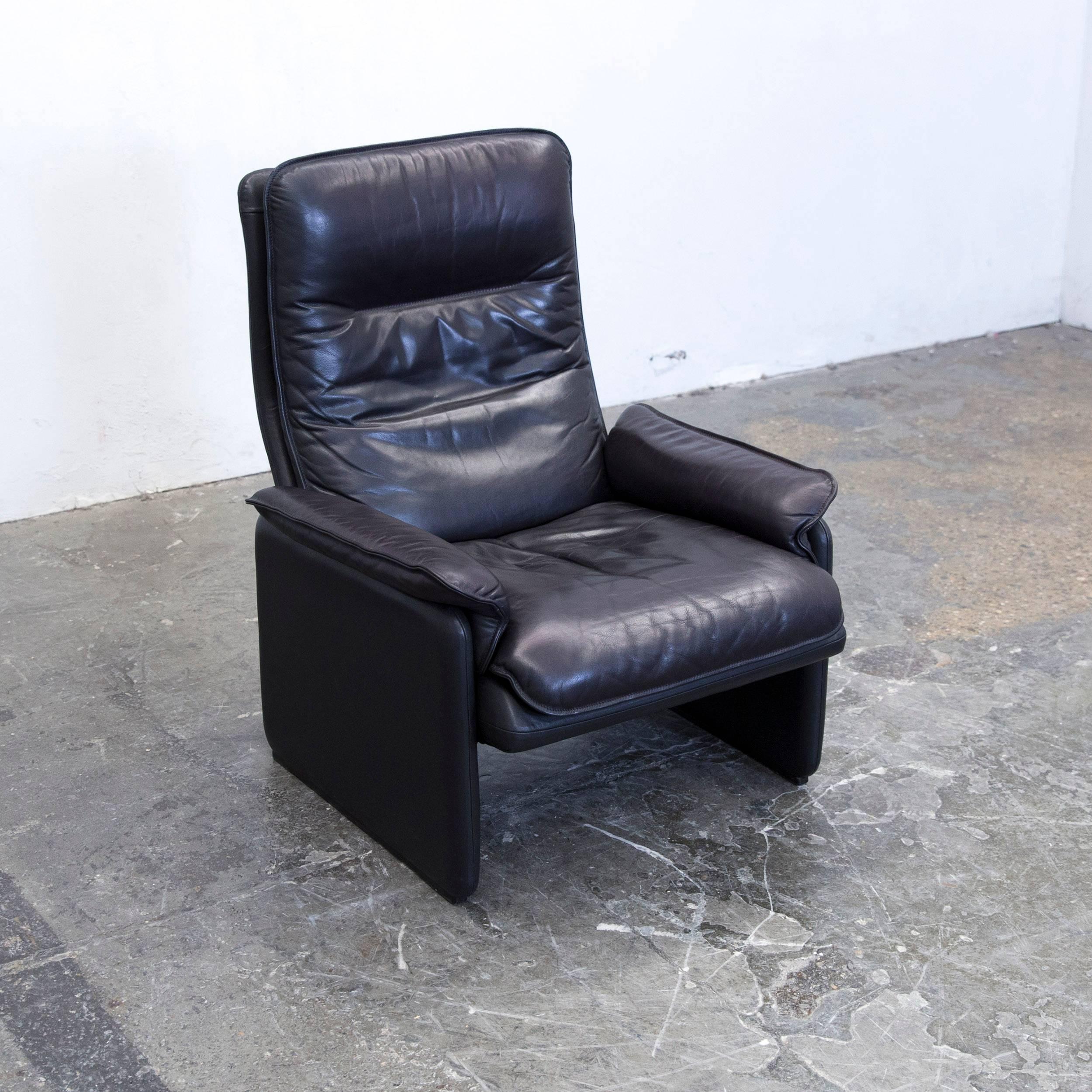 Aubergine black colored original de Sede designer leather armchair, in a minimalistic and modern design, with a convenient relax function, made for pure comfort.