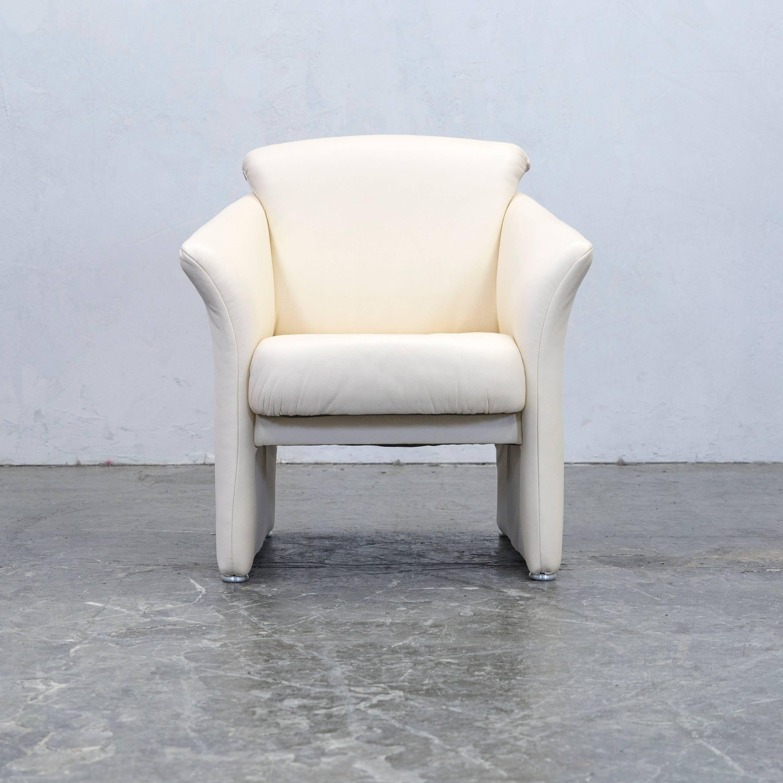 Crème colored designer leather armchair, in a minimalistic and modern design, made for pure comfort.