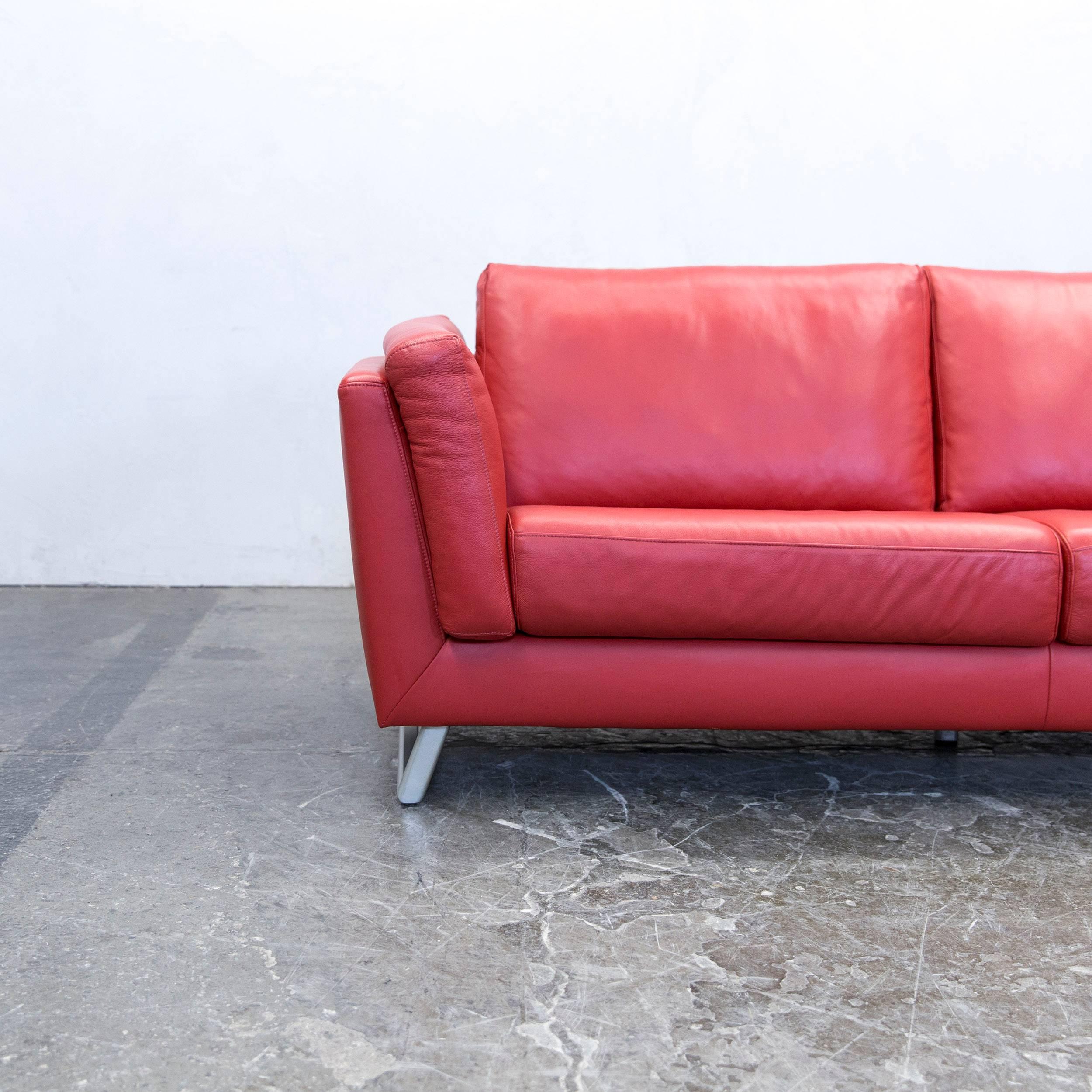 Red colored designer leather sofa, in a minimalistic and modern design, made for pure comfort.