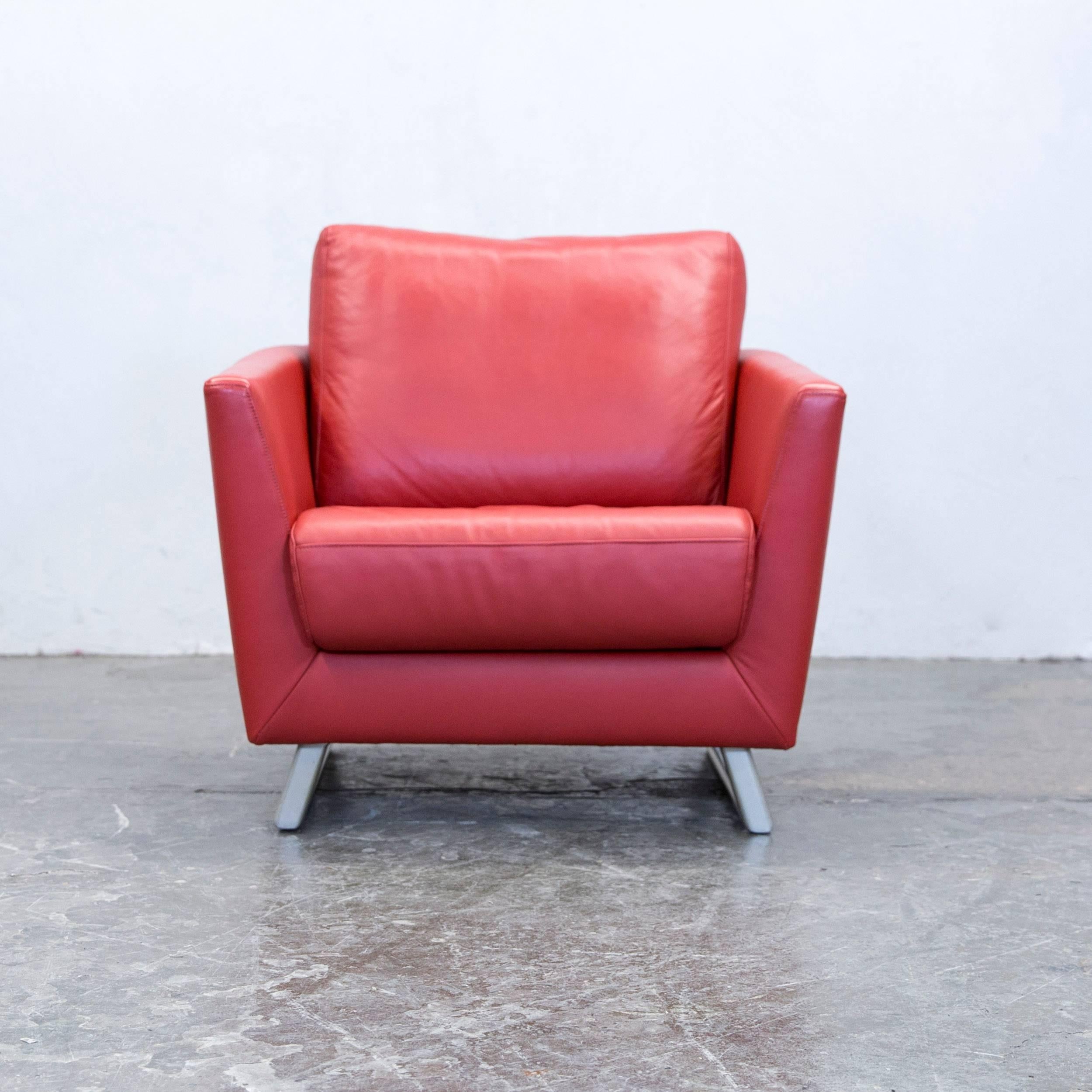 Red colored designer leather armchair, in a minimalistic and modern design, made for pure comfort.