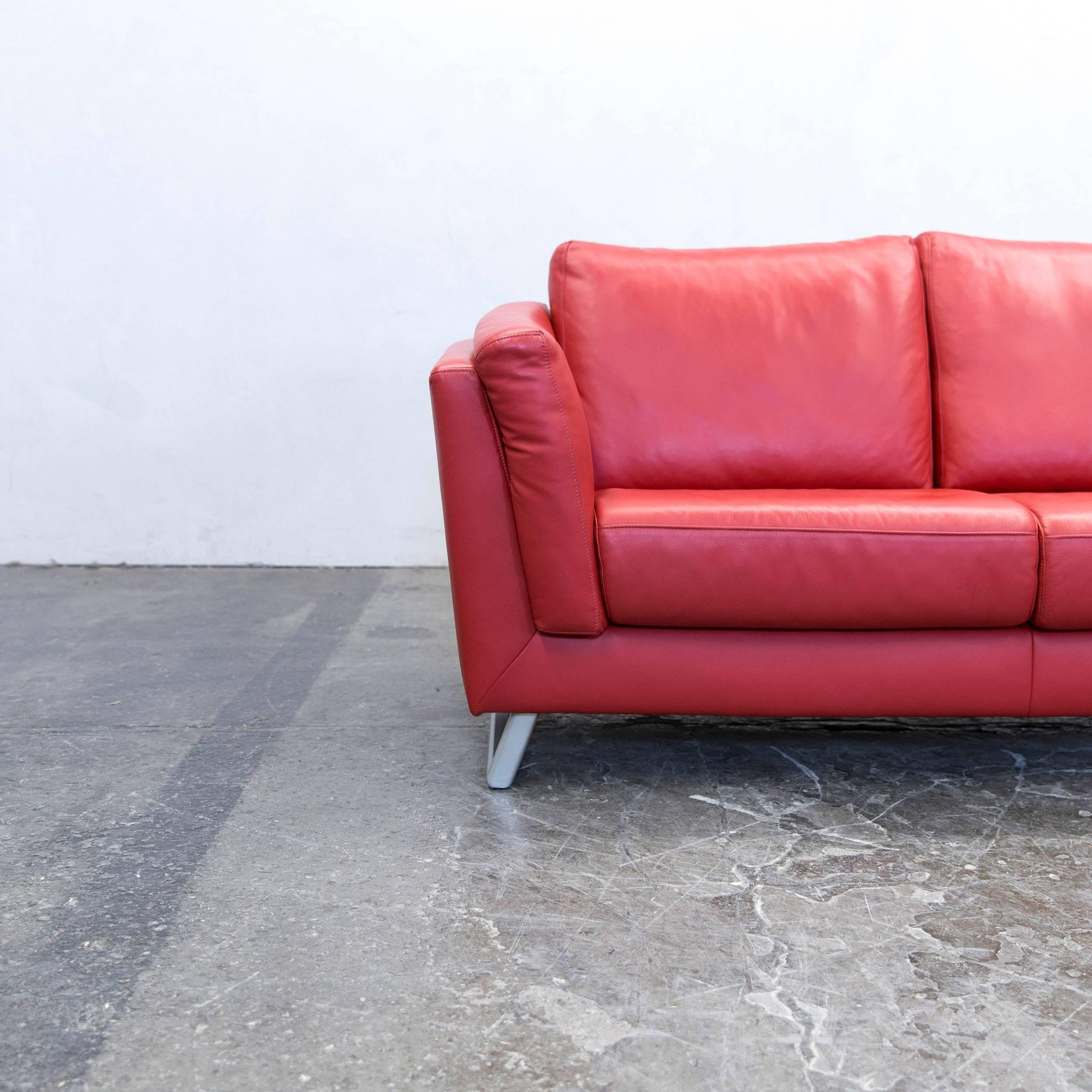 Red colored designer leather sofa, in a minimalistic and modern design, made for pure comfort.