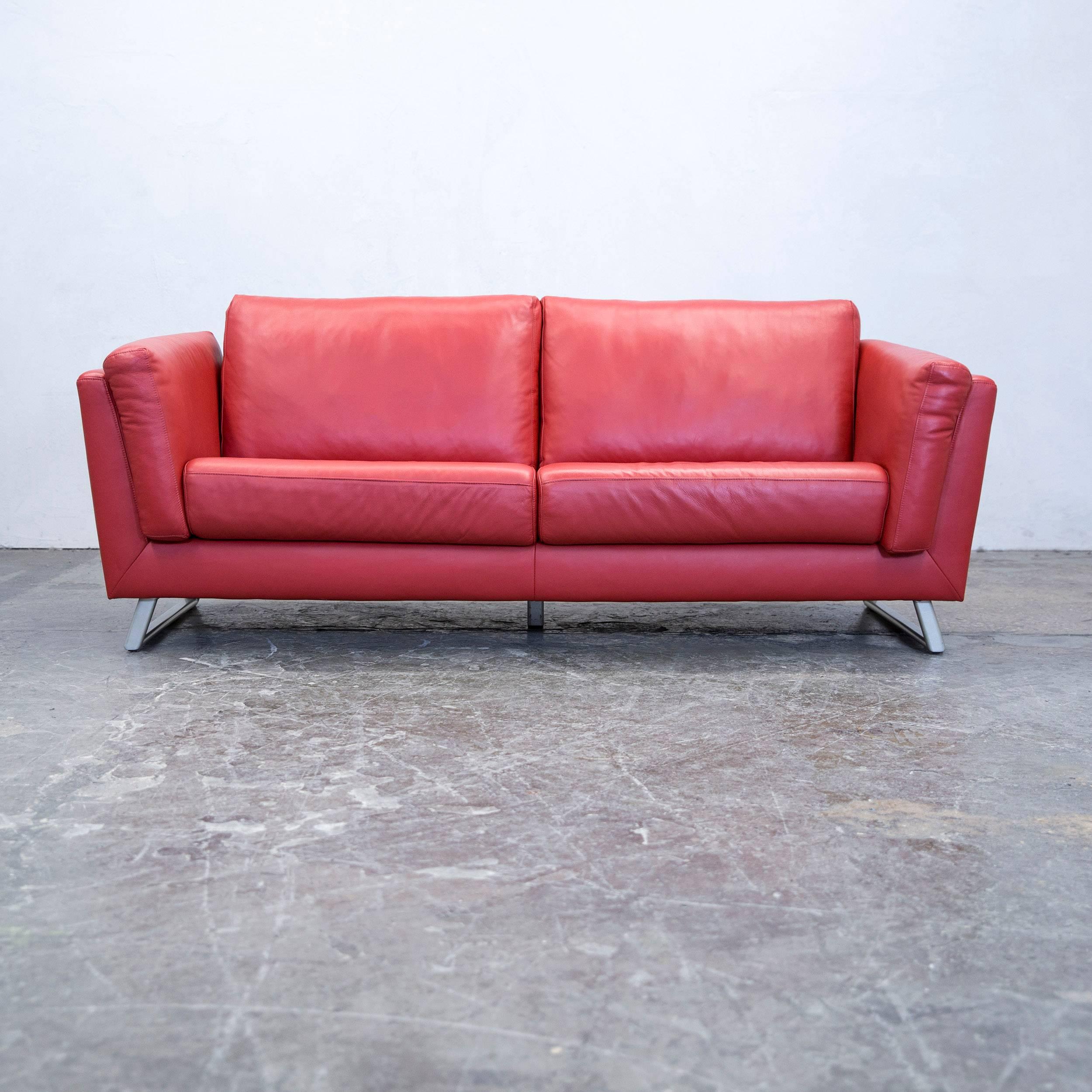 Red colored designer leather sofa and armchair, in a minimalistic and modern design, made for pure comfort.