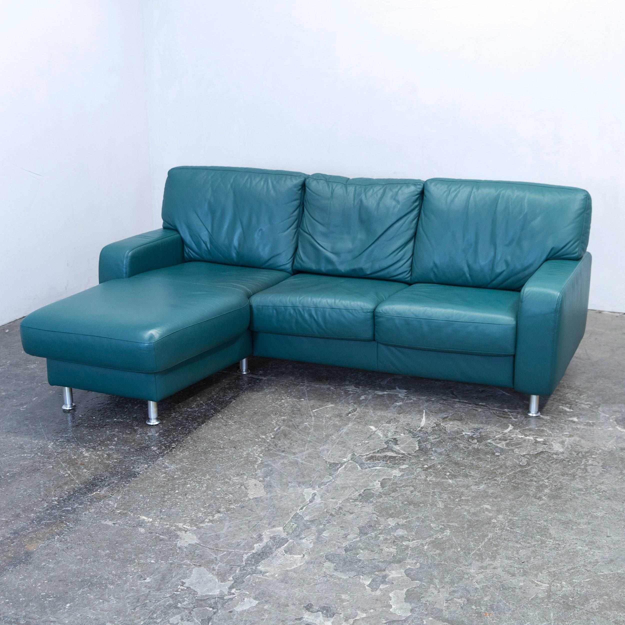 Green colored original Koinor designer leather sofa, in a minimalistic and modern design, made for pure comfort and style.