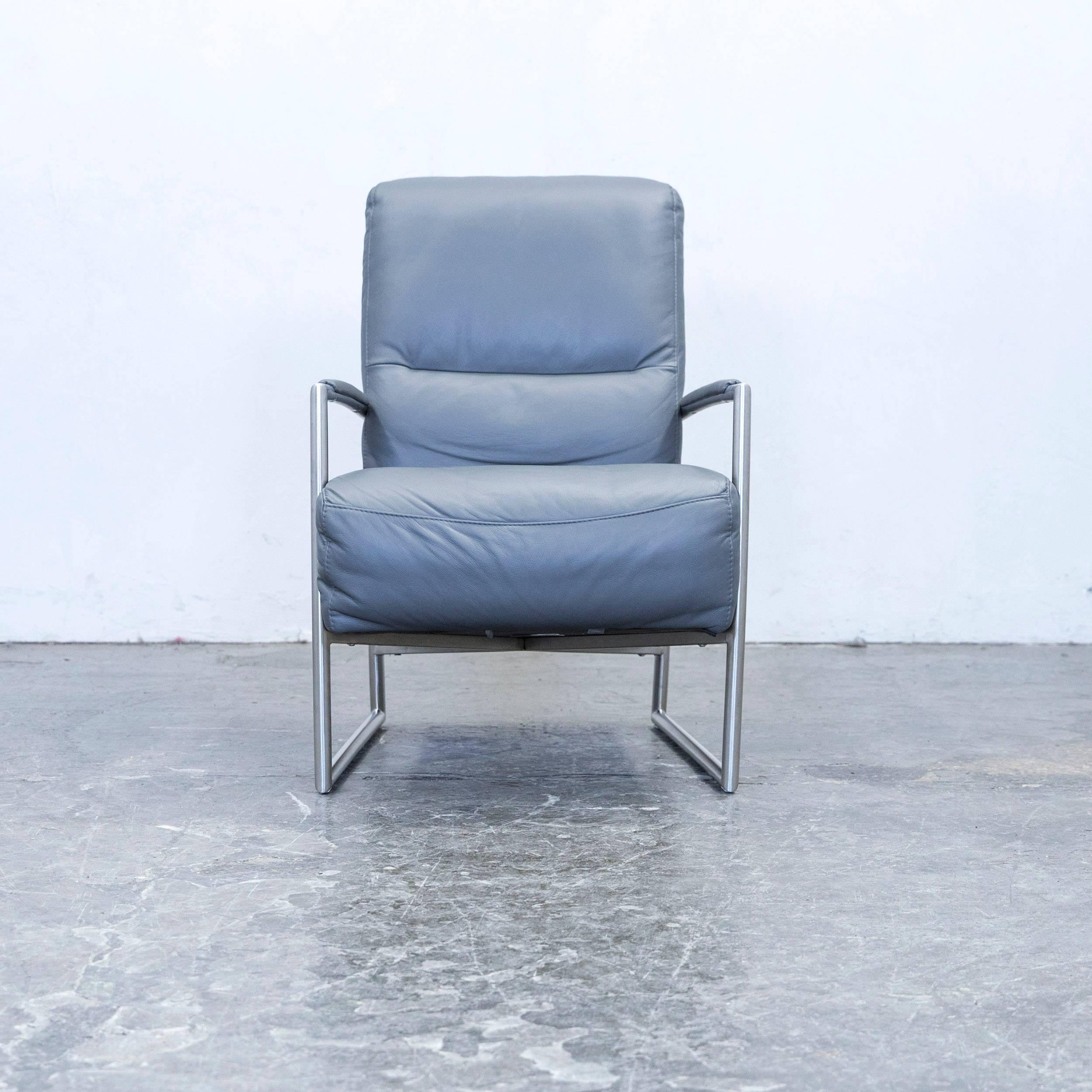 Grey colored Musterring designer leather armchair, in a minimalistic and modern design, made for pure comfort.