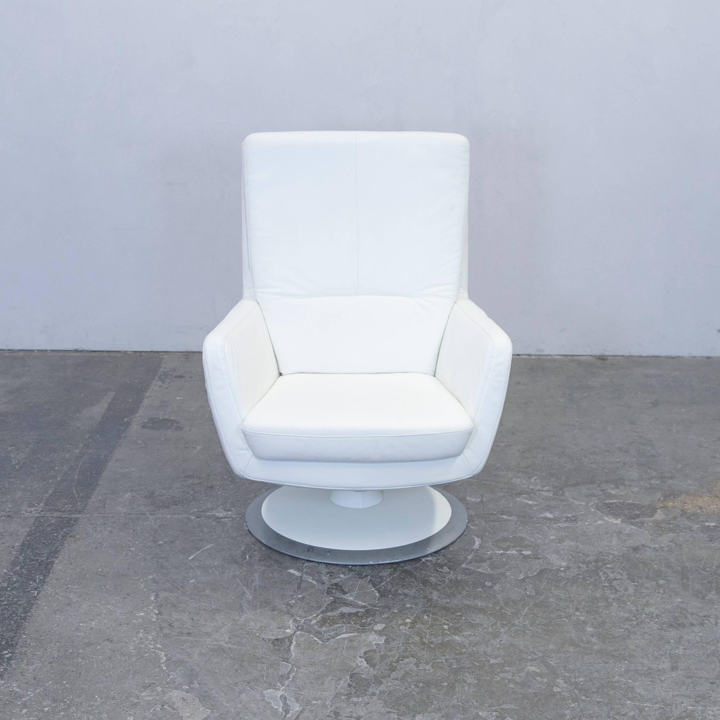 White colored Musterring designer leather armchair, in a minimalistic and modern design, made for pure comfort.